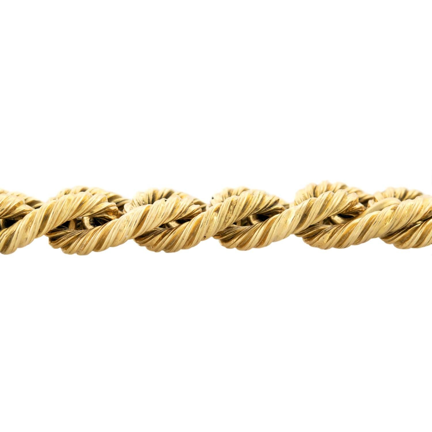 This fabulous Vintage (ca.1960) gold bracelet is a signed piece by Tiffany & Co.! The 18kt gold bracelet is comprised of heavy twisted curb links held close together by smaller, smooth curb links, forming a stylish statement piece that wraps around