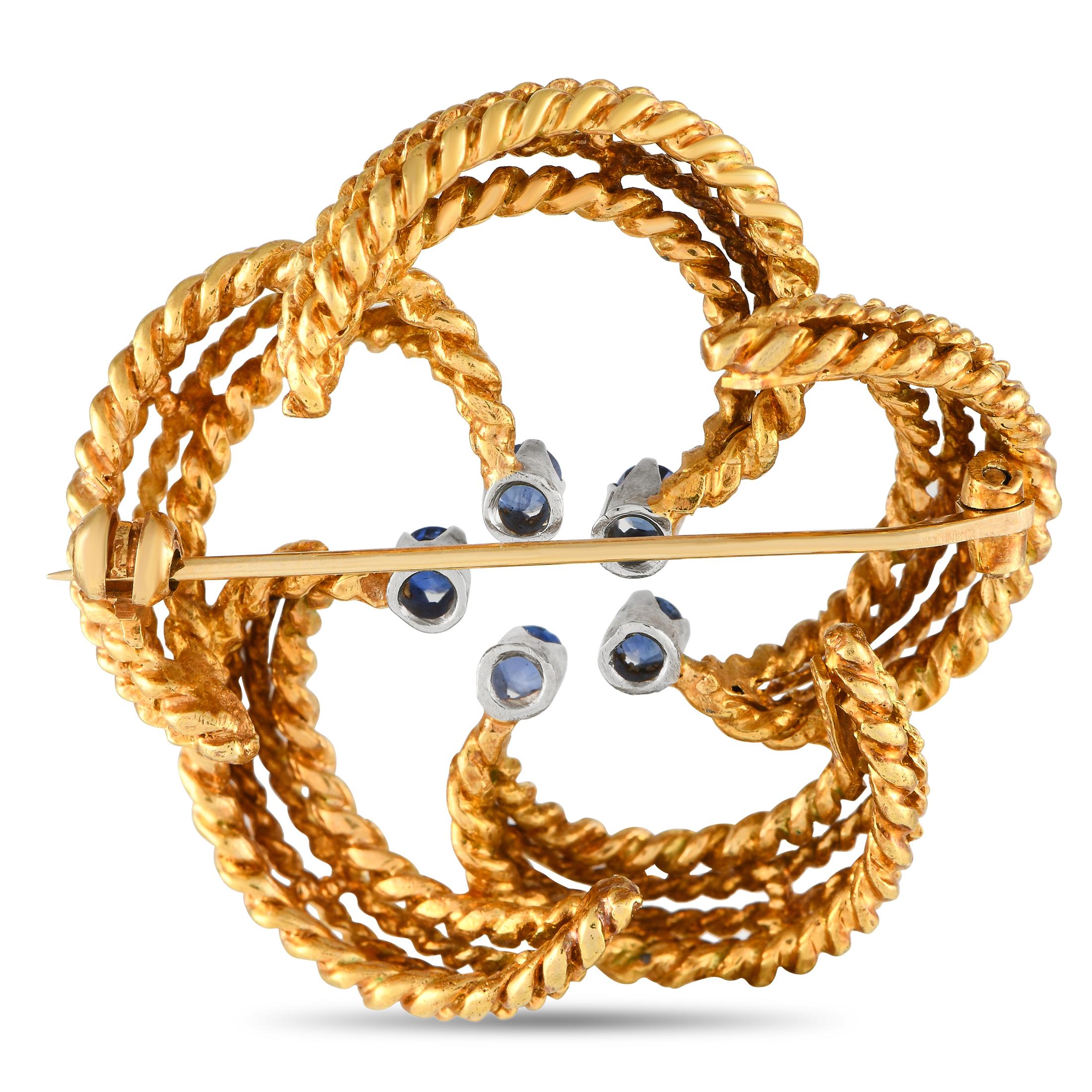 Intricate metalwork, curved lines, and captivating Sapphire gemstones come together to make this vintage Tiffany & Co. brooch simply unforgettable. Crafted from opulent 18K Yellow Gold, it measures 1.45 round and will secure easily to any scarf,