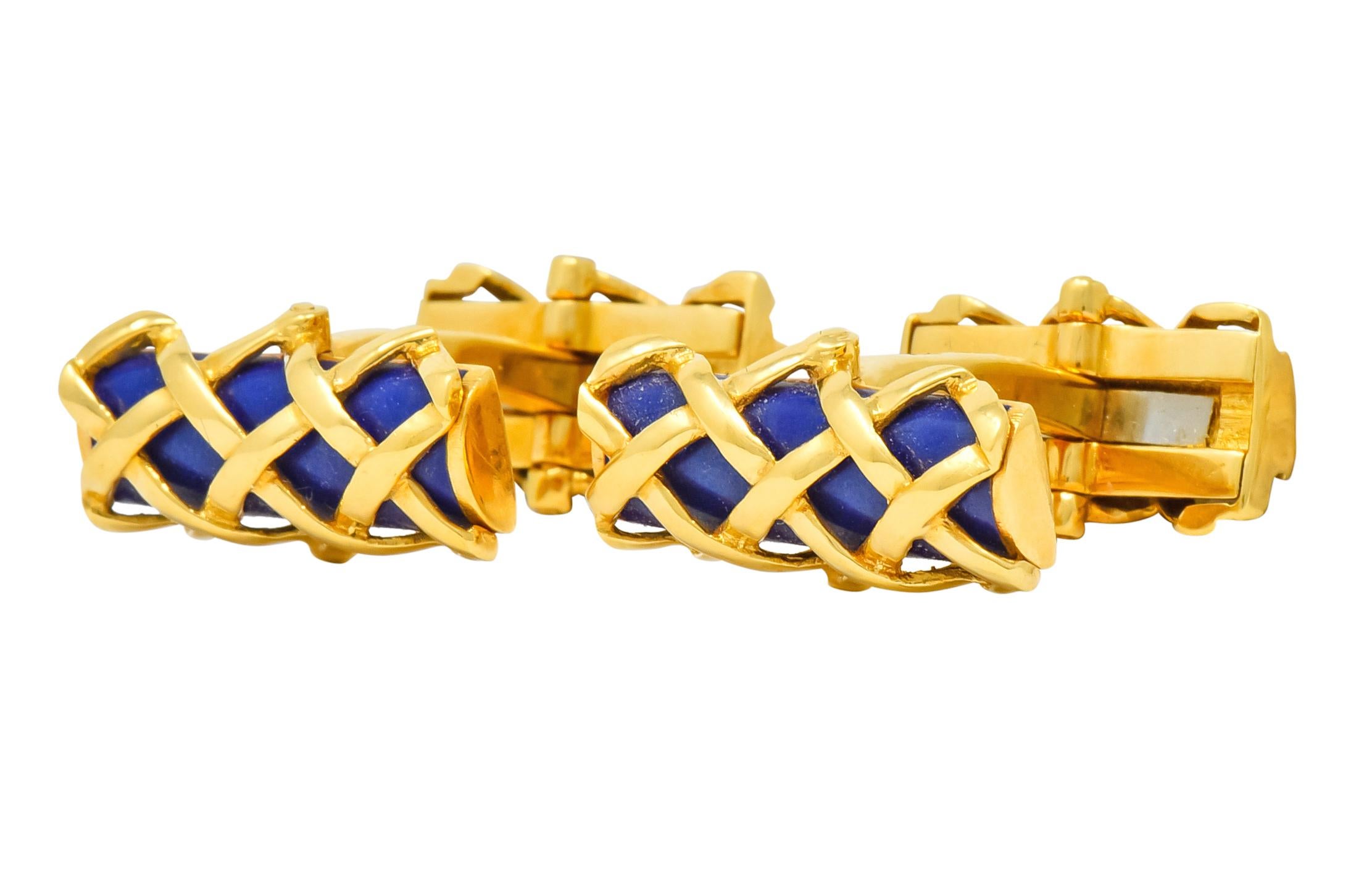 Lever style cufflinks terminating as two rectangular lattice cages with a high polished gold finish

Each contains a rounded bar of bright ultramarine blue enamel with no loss

Fully signed Tiffany & Co.

Stamped 750 for 18 karat gold

Circa
