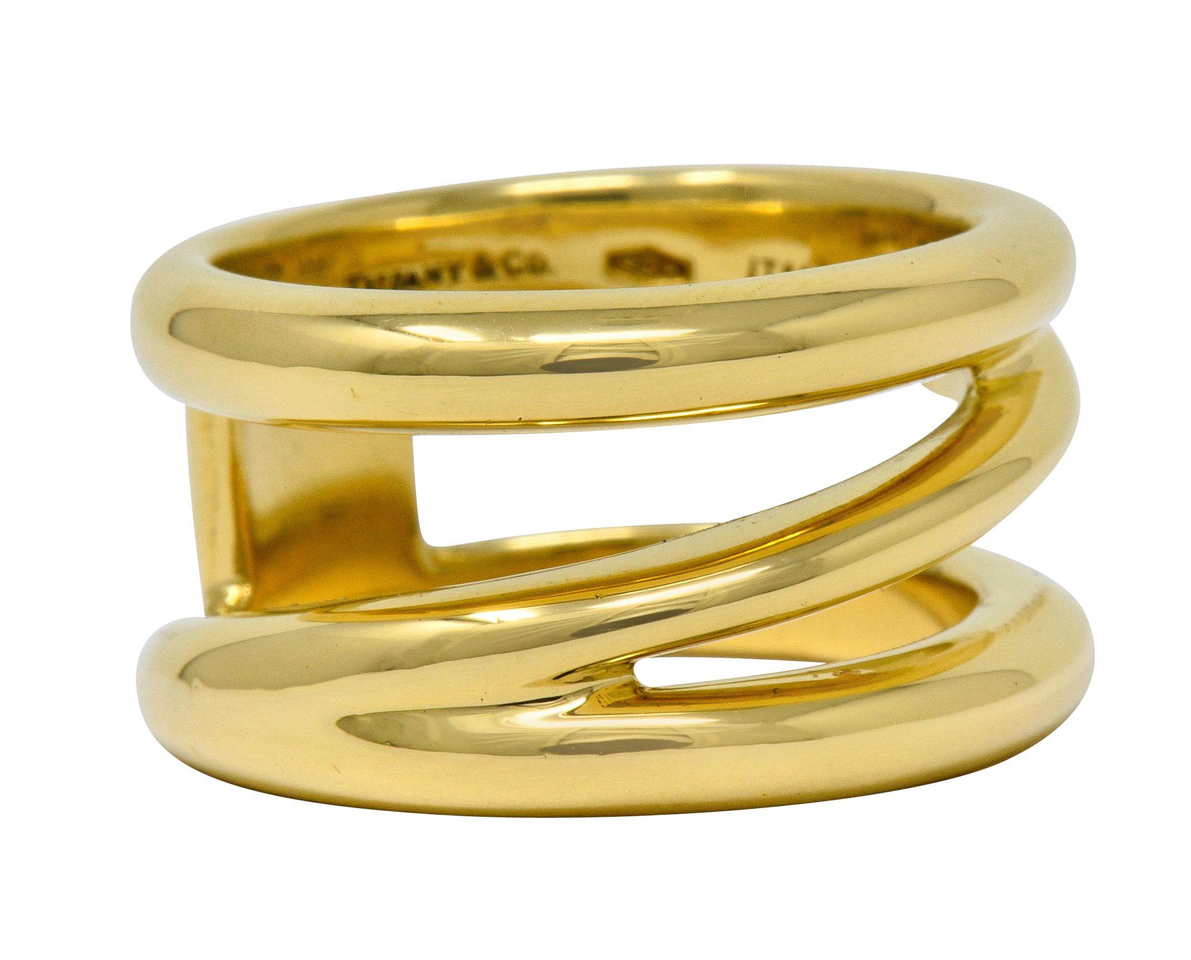 Wide band ring designed as three segments of gold that zig-zag into one another

Featuring a bright polish

Fully signed Tiffany & Co. Italy

Stamped 750 for 18 karat gold

Circa: 1990s

Ring Size: 5 3/4 & sizable

Measures: 11.1 mm wide and sits