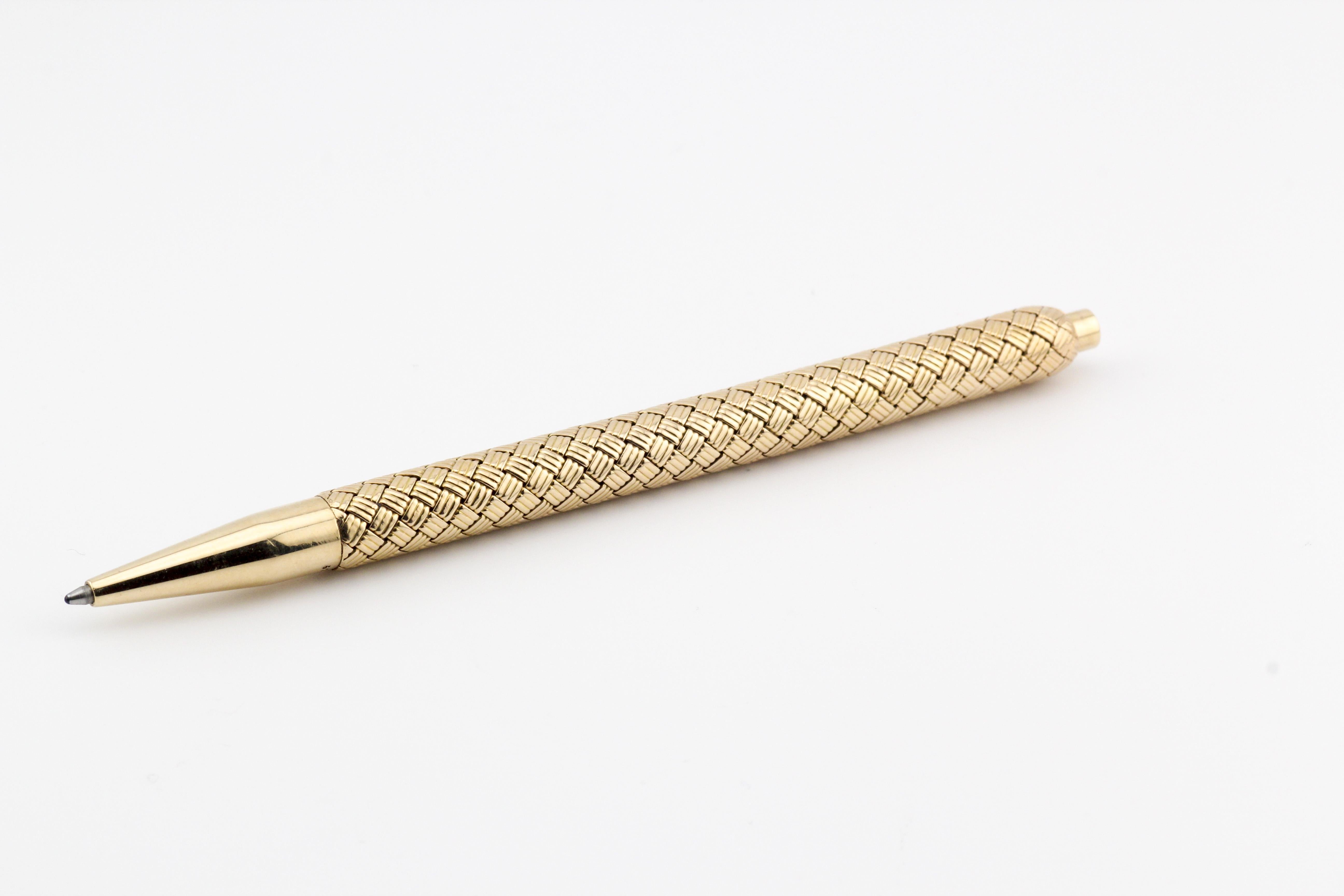 Step into a world of timeless sophistication with this exquisite Tiffany & Co. Vintage Basket Weave 14K Yellow Gold Ballpoint Pen. Meticulously crafted, this pen is a testament to the enduring elegance and impeccable craftsmanship synonymous with