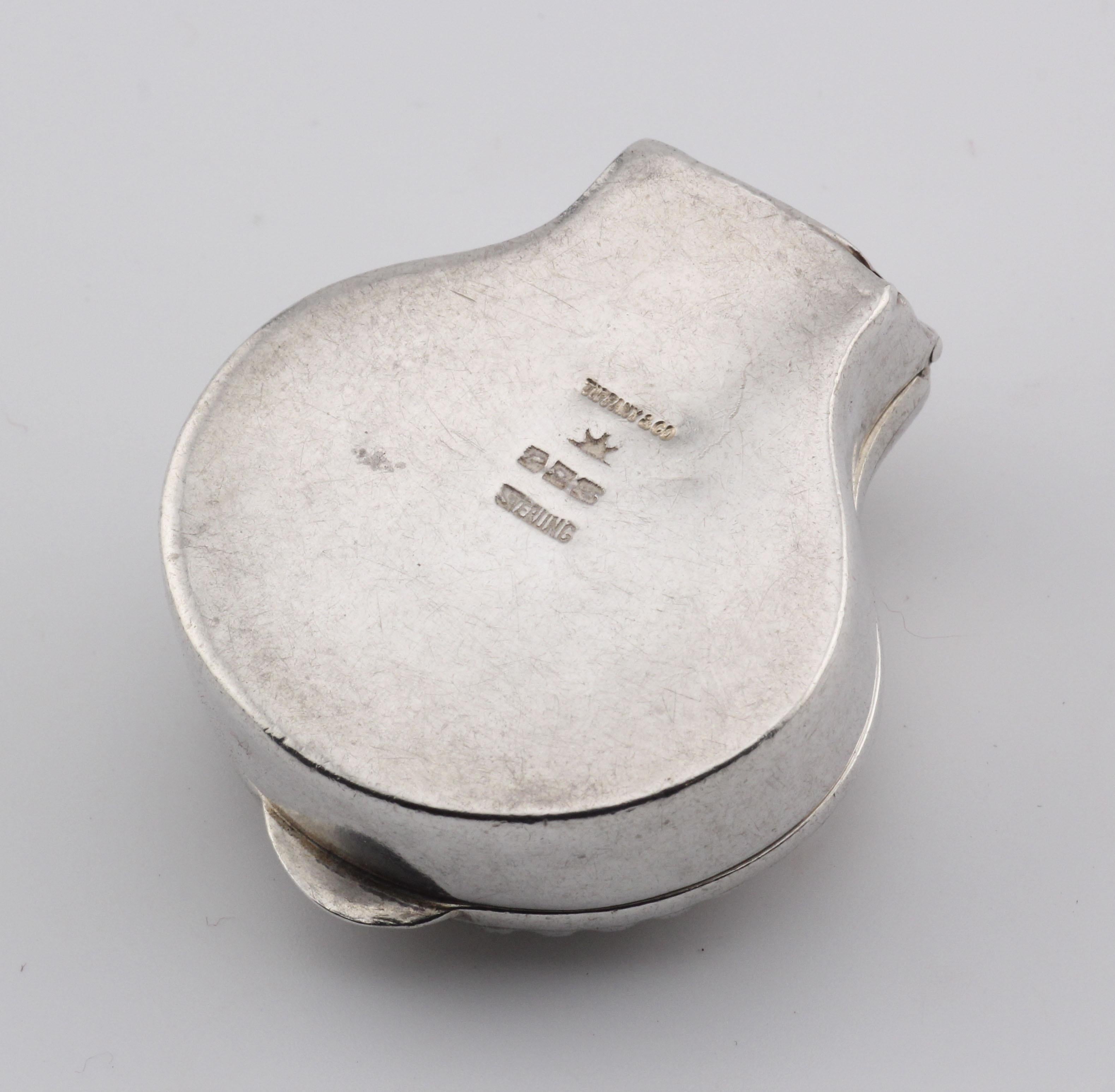 The Tiffany & Co. Vintage Clam Shell Sterling Silver Pill Box Case is a captivating piece that blends the elegance of nature with the timeless craftsmanship of Tiffany & Co. This collectible pill box is a beautiful example of the brand’s ability to