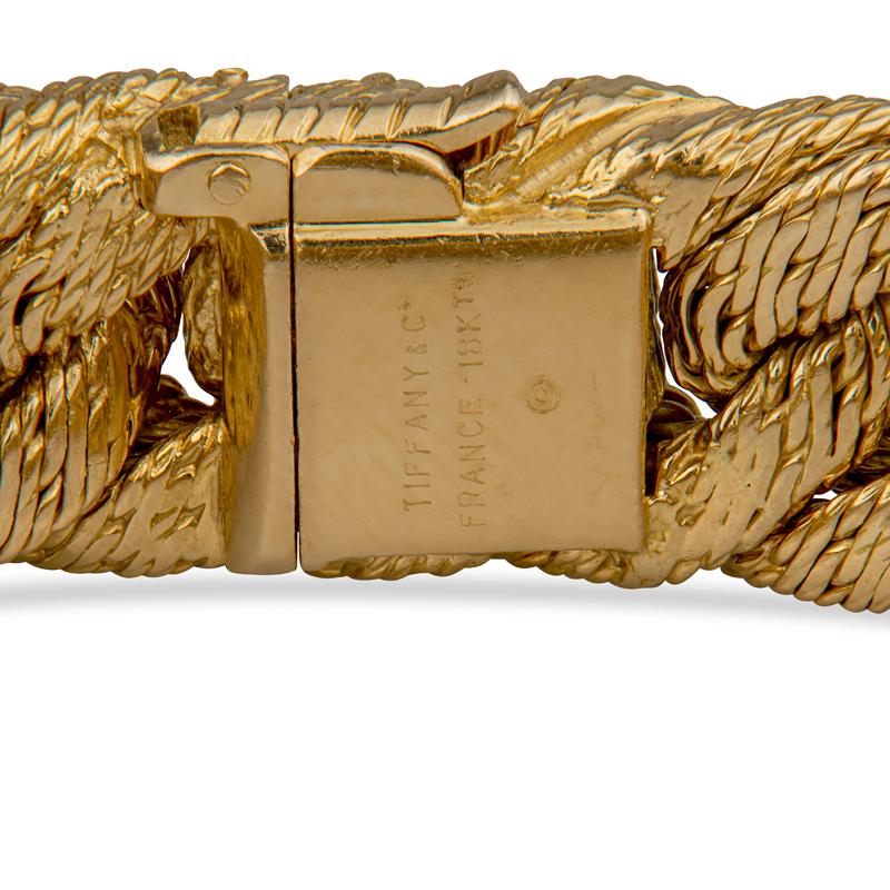 This vintage bracelet from Tiffany & Co. is a cuban style braided bracelet crafted in 18 karat yellow gold. Box with safety clasp. Make a statement in this unique vintage piece! This bracelet weighs 82.0 grams. The makers mark and eagle mark are