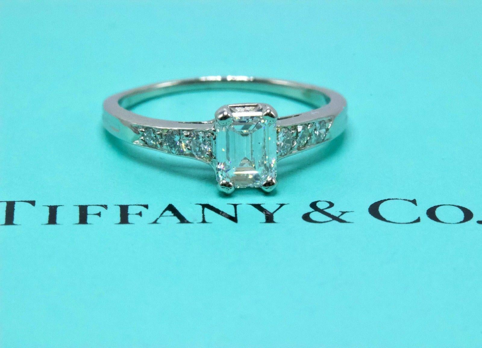 Tiffany & Co.

Style:  Vintage Diamond Engagement Ring
Metal:  Irradiated Platinum
Size:  4 - sizable
Total Carat Weight:  0.69 TCW
Diamond Shape:  Emerald Cut 0.45 CTS
Diamond Color & Clarity:  E - F / SI1
Accent Diamonds:  6 Round Diamonds 0.24