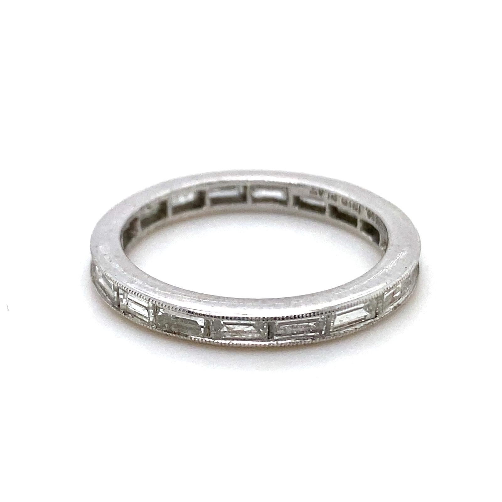 A Tiffany & Co vintage diamond full eternity ring in platinum, circa 1950.

This exceptional full eternity band is set with a single row of baguette cut diamonds, totalling 0.90 carats approximately all of high colour and clarity, assessed by