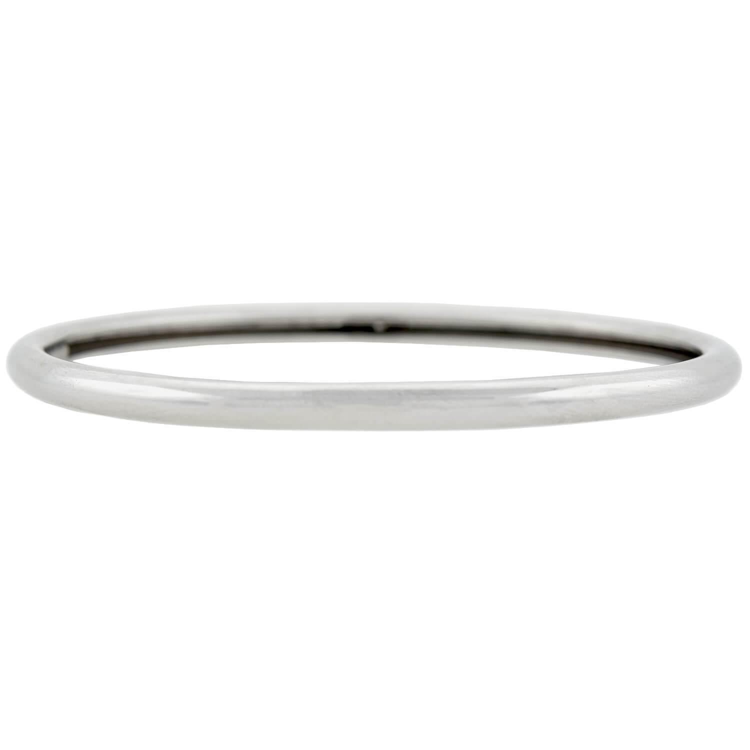 A fabulous Vintage (ca1993) bracelet by the legendary fashion house Tiffany & Co.! Crafted in 18kt white gold, this slip-on style bangle features a smoothly polished finish which carries along the entire surface, reflecting the light beautifully