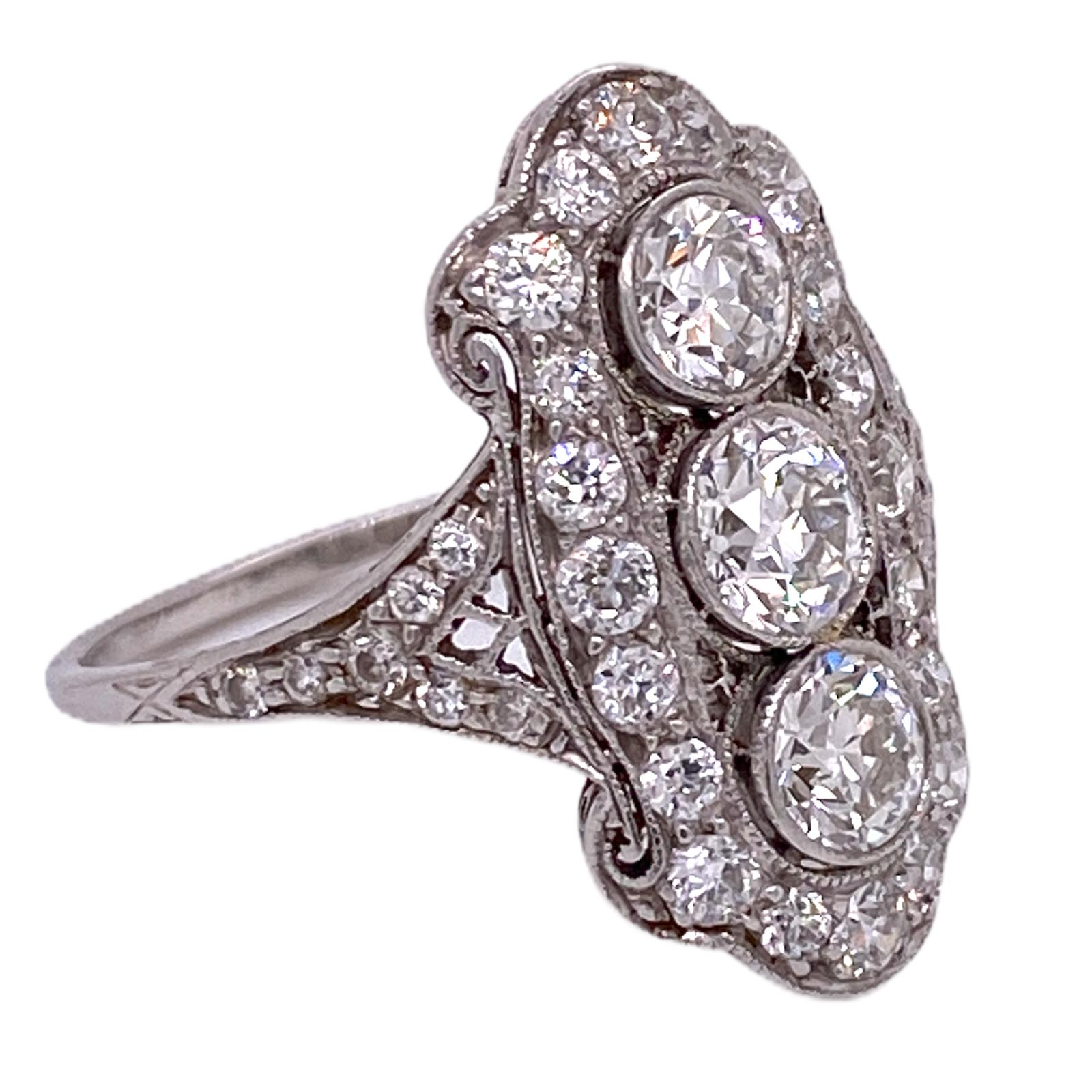 Gorgeous Tiffany & Co. diamond cocktail ring, circa 1930's, is handcrafted in platinum. The three Old European Cut Diamonds weigh approximately 1.62 carat total weight, and the side OEC's weigh another 1.00 carat total weight. The diamonds are
