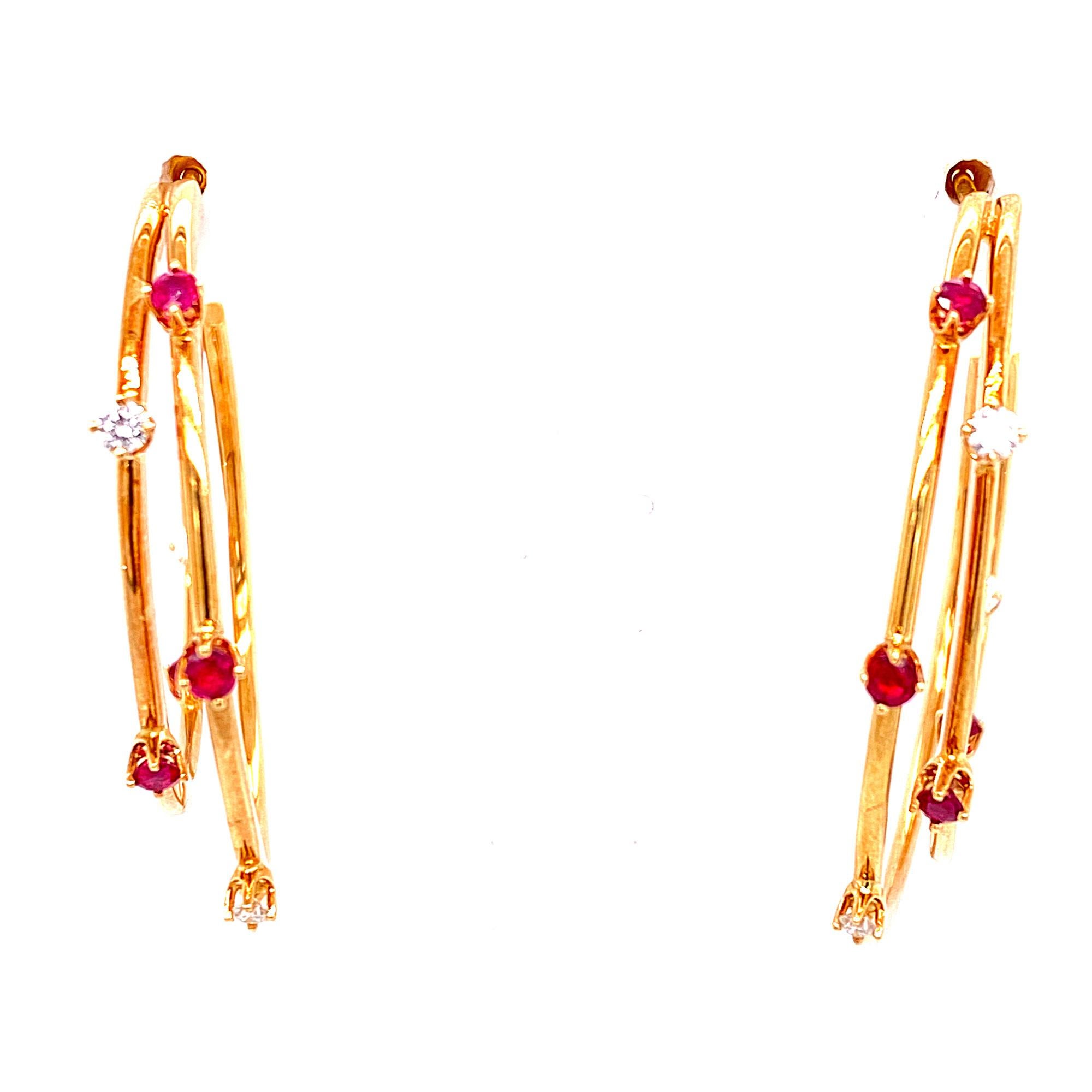 Chic pair of earrings from Tiffany & Co. These vintage hoops are crafted from 18k yellow gold in a fine polished finish and double hoop style, each wire hoop adorned with 8 round cut rubies gemstones and 6 round brilliant cut diamonds. The earrings