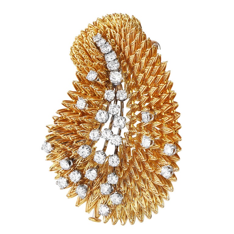 Feel out of this world, with this expertly made Tiffany & Co. Diamond Brooch.

This collectible brooch was made in France around the 1960s.  It holds approx. 33 natural diamonds totaling ---- Carats.  The diamonds are alternating sizes of round-cut,
