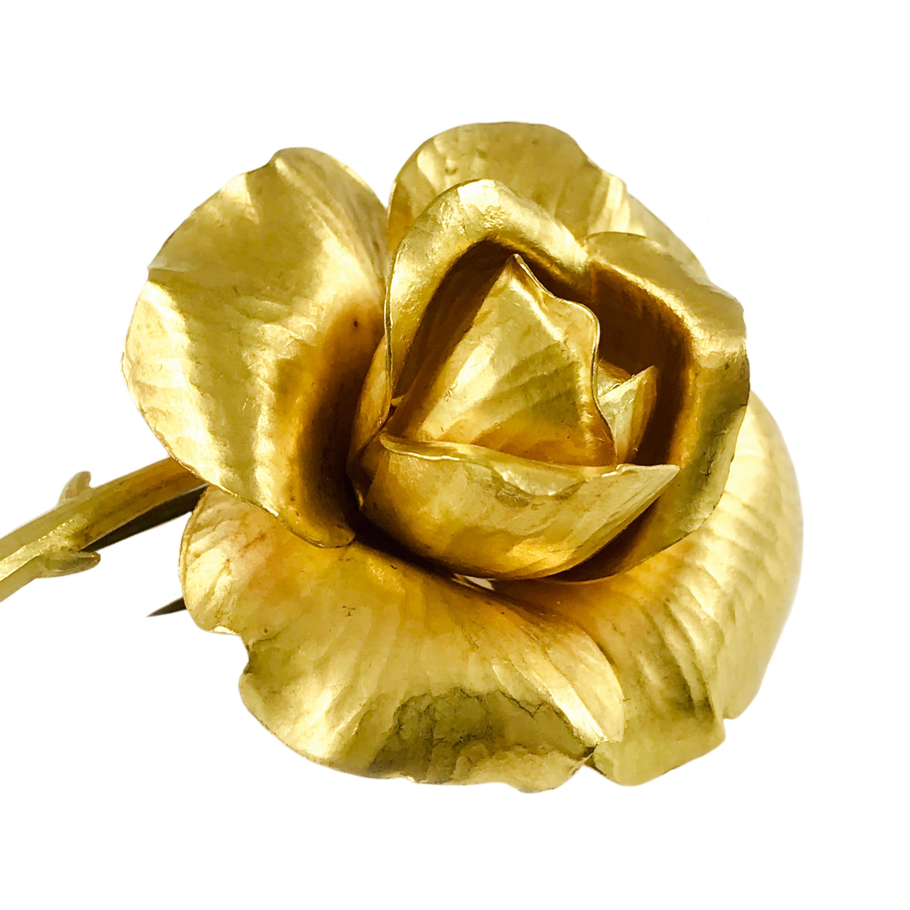 Tiffany & Co. Vintage 18 karat yellow gold rose brooch/pin. Meticulously handcrafted hammered petals with a lovely stem cut in a diagonal and two small curved thorns in an overall satin finish. Double pins and push-pull safety closure. Also, on the
