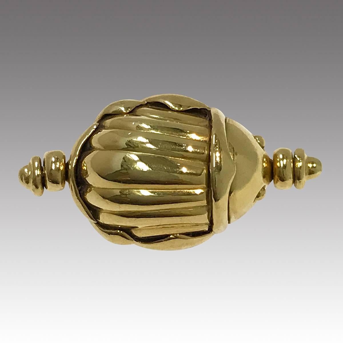 Tiffany & Co. Vintage 18k Gold Scarab Flip Ring. This famous maker ring showcases a scarab beetle with a ridged body and two bead eyes on the top of the ring and on the flip-side of the scarab body is stamped “© T & Co. 750”. The scarab beetle