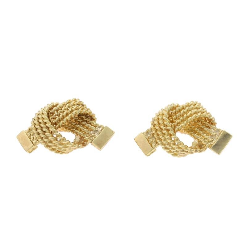 Marke: Tiffany & Co.
Epoche: Vintage By

Metallgehalt: 14k Gelbgold

Stil: Ohrstecker
Verschlusstyp: Schmetterlingsverschlüsse
Thema: Knoten
Merkmale: Seil strukturierte Detaillierung

Messungen

Höhe: 7/16