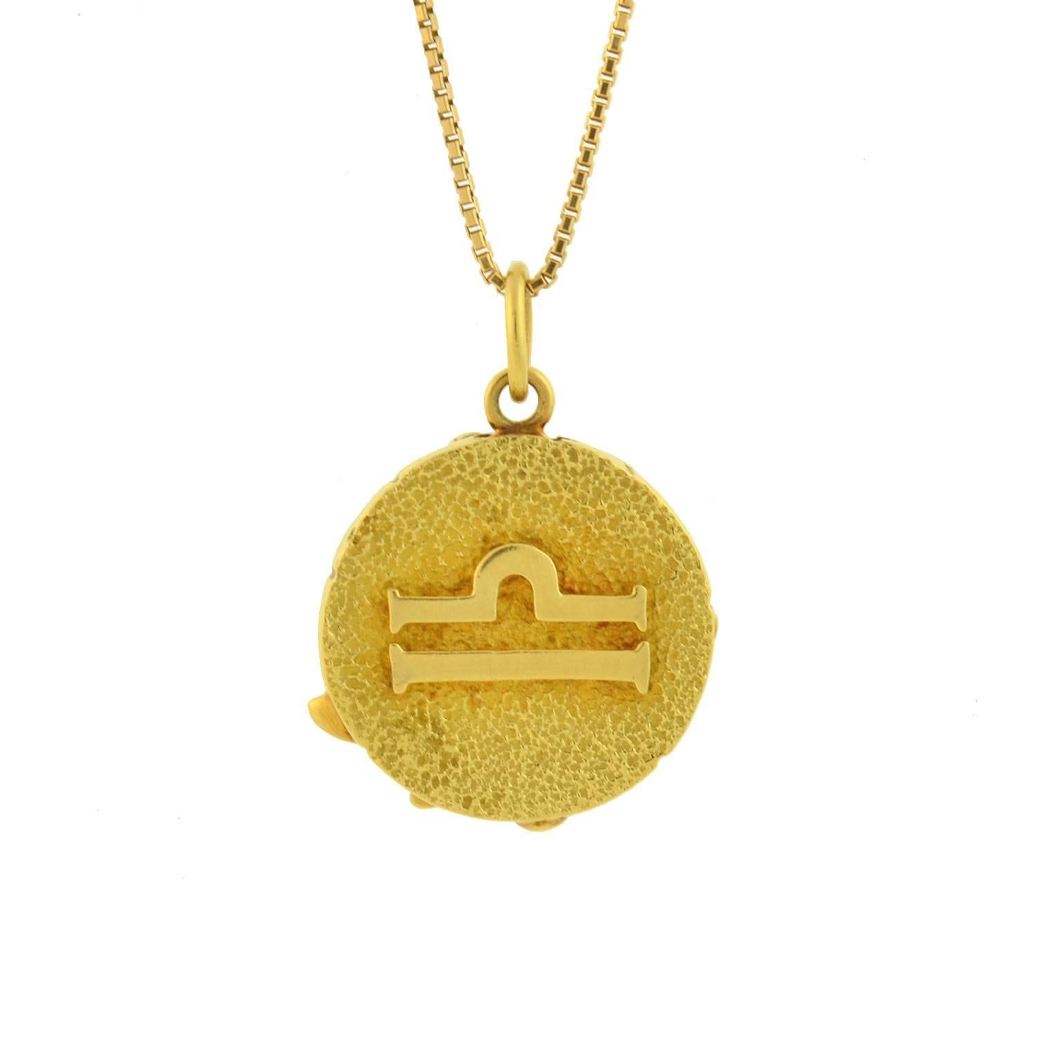 A fabulous Vintage pendant designed by legendary maker Tiffany & Company! This wonderful zodiac piece, which is from the 1960's, is crafted in 18kt yellow gold and comprised of a bold pendant depicting the astrological sign for Libra which hangs