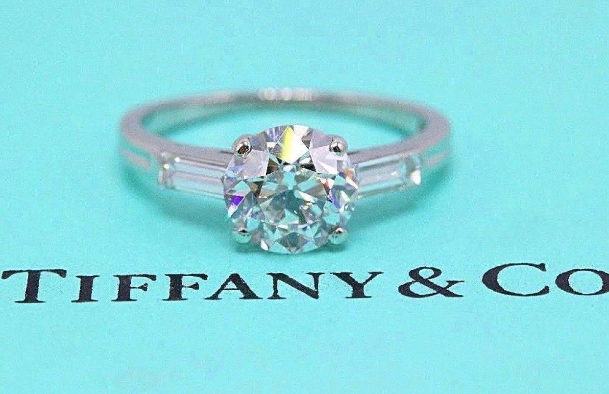 Tiffany & Co. Vintage Old Cut Diamond Engagement Ring with Two Baguette Diamonds on the sides set in Palladium.  Center Old European Round Cut Diamond 1.45 CTS G color, VVS2 clarity.... 2 Side Baguette Diamonds 0.27 TCW F color, VVS2 clarity.  Size