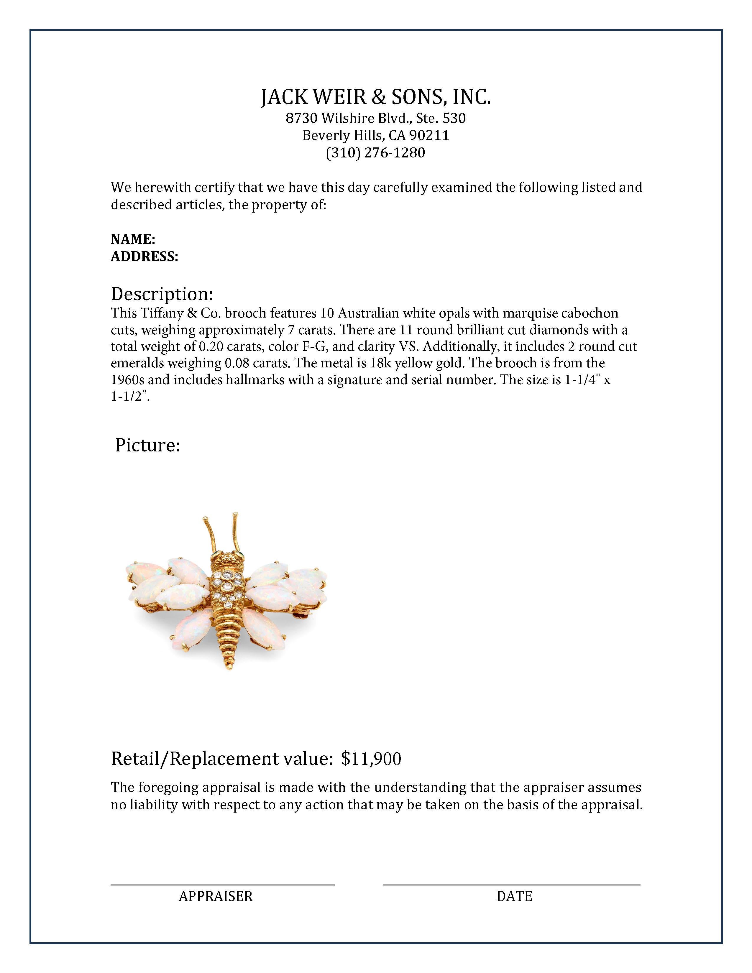 Brand: Tiffany & Co.
Center Stone: 10 Australian white opals
Cut: Marquise cabochon
Weight: 7 carats approximately 
Accent Stone: 11 diamonds 
Cut: Round brilliant 
Weight: 0.20 carats 
Color: F-G 
Clarity: VS
Accent Stones: 2 emeralds
Cut: