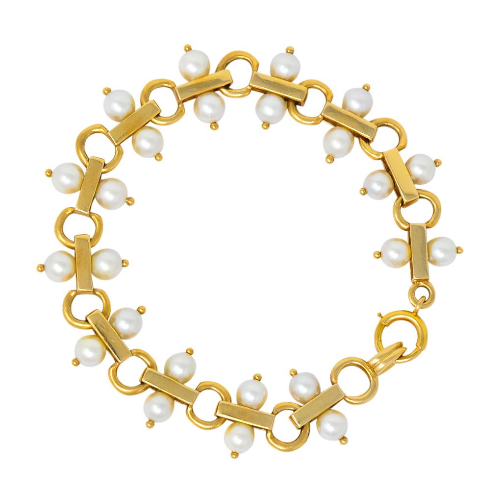 Bracelet features gold bar links and open circle links, alternating

Each gold bar link is flanked by two round pearl beads, cream in body color with rosé overtones and very well matched

Accented by small gold beads at each pearl

Completed by