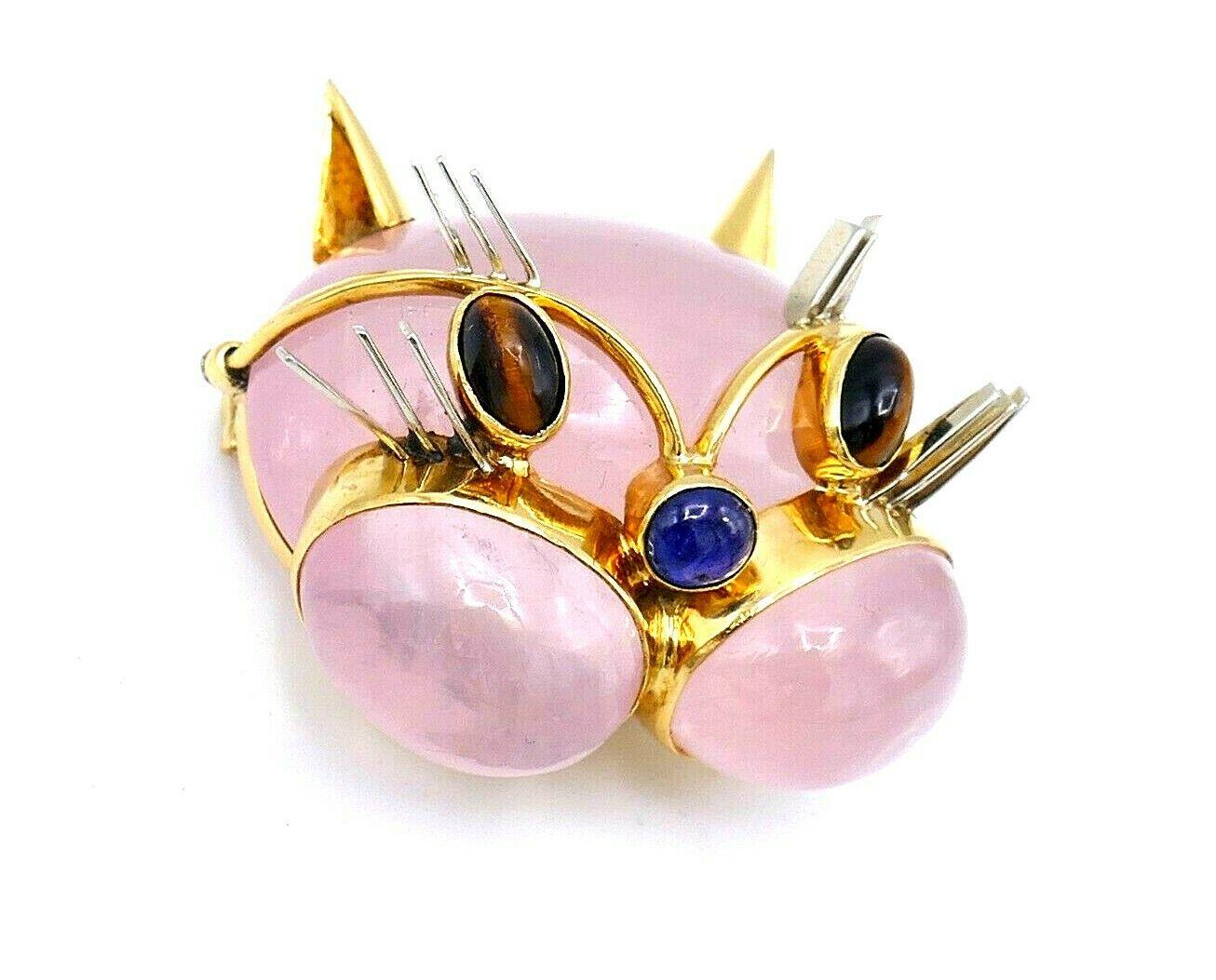 Cute vintage Cat Face brooch by Tiffany & Co. made of pink quartz and 18k yellow gold. Features tiger's eye, sapphire and white gold. Stamped with Tiffany & Co. maker's mark, hallmark for 18k gold and a country of origin (Italy).
Measurements:  1