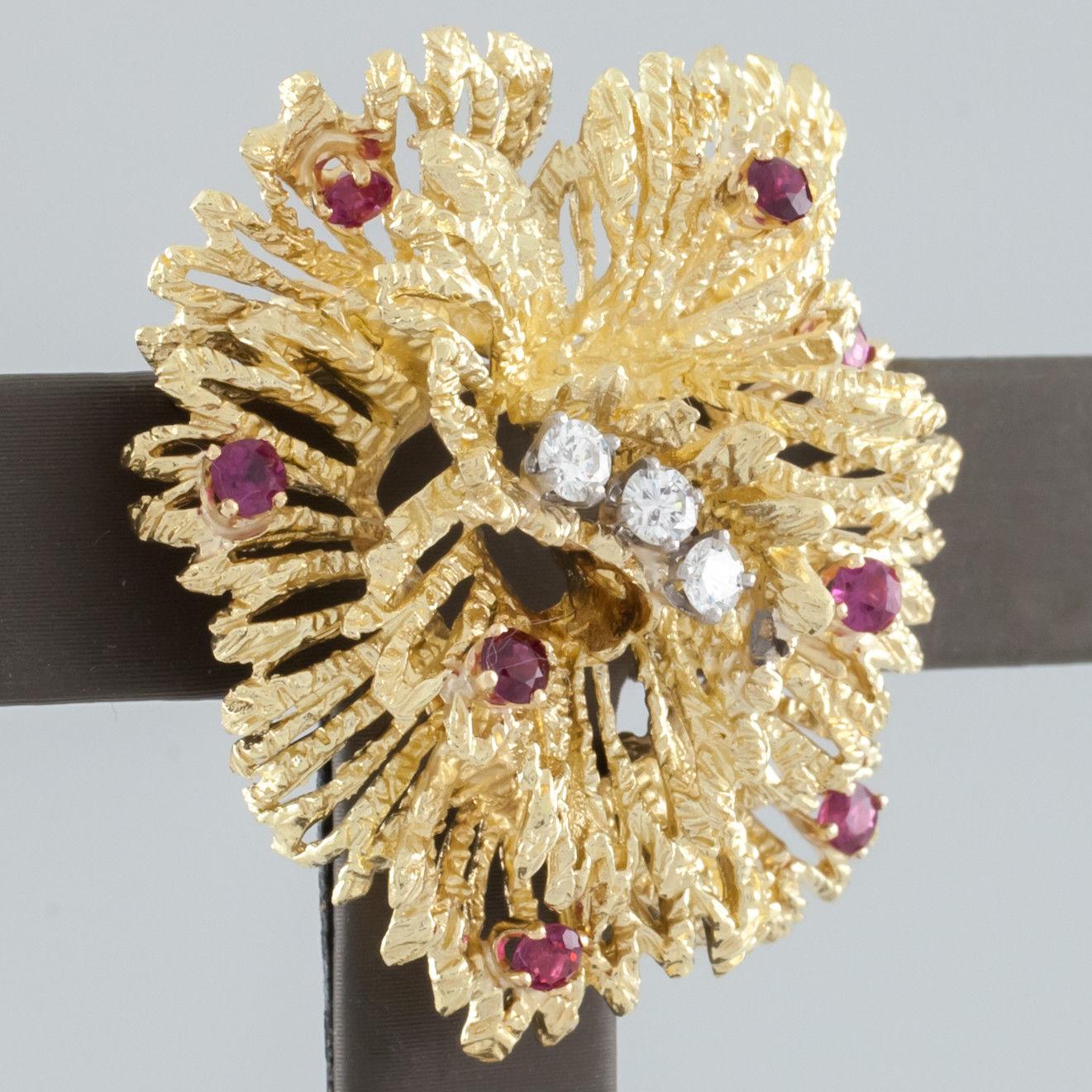 Gorgeous Tiffany & Co. Brooch
Features Floral or Anemone Design with Three Center Diamond Solitaires and Round Rubies Throughout
Brooch is Approximately 38 mm Wide x 36 mm Long
Total Mass = 17.4 grams
Piece is in Good Condition. Shows Few Signs of