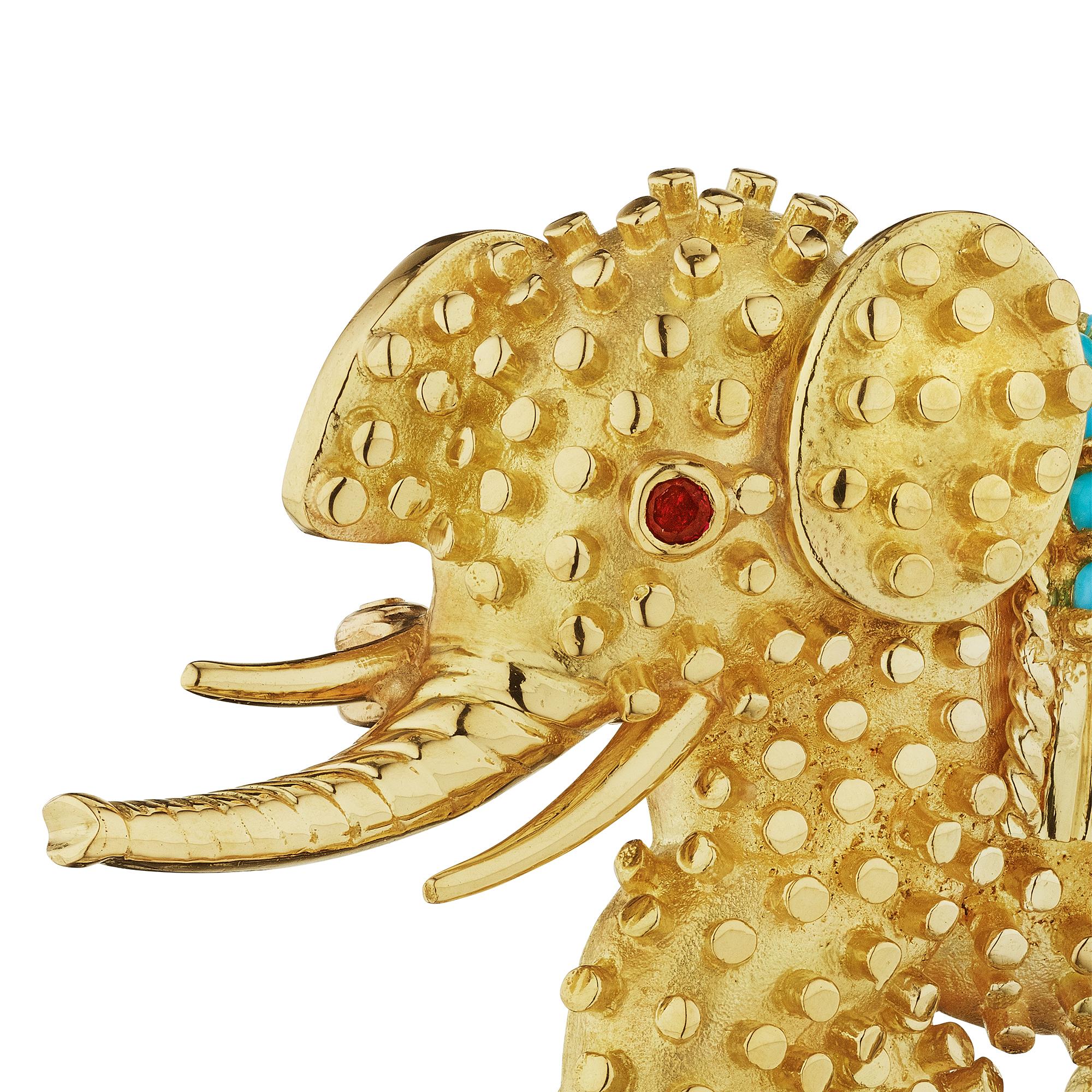Symbolizing strength and good fortune this Tiffany & Co. vintage ruby, turquoise, and 18 karat yellow gold elephant brooch will lead the way to all good things.  Walking proudly with his trunk up for good luck, this is a one-of-a-kind and