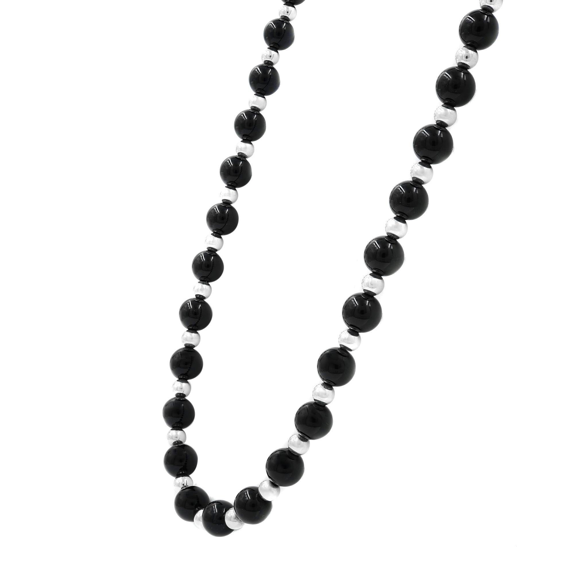 Tiffany & Co Vintage Sterling Silver & Black Onyx 31 Inch Single Strand Necklace. This stunning necklace has a small round tag that is engraved with the old Tiffany hallmark: T & CO STERLING. It weighs 50.9 grams. The large onyx beads measure 8.3 mm