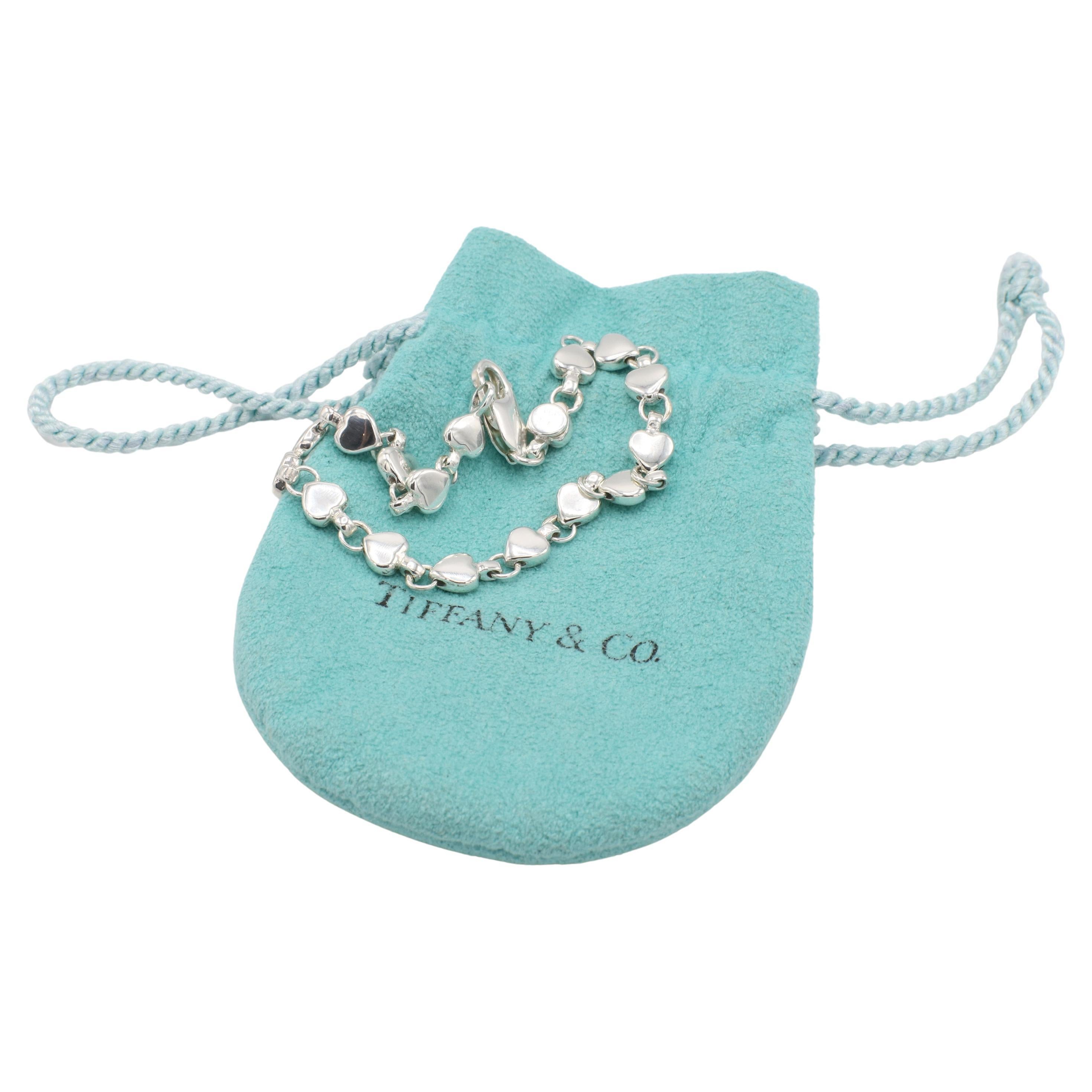 Tiffany & Co. Vintage Sterling Silver Heart Link Bracelet 
Metal: Sterling silver 925
Weight: 11.85 grams
Length: 7 inches
Width: 5.5mm
Signed: T&Co. 925 (fading)
