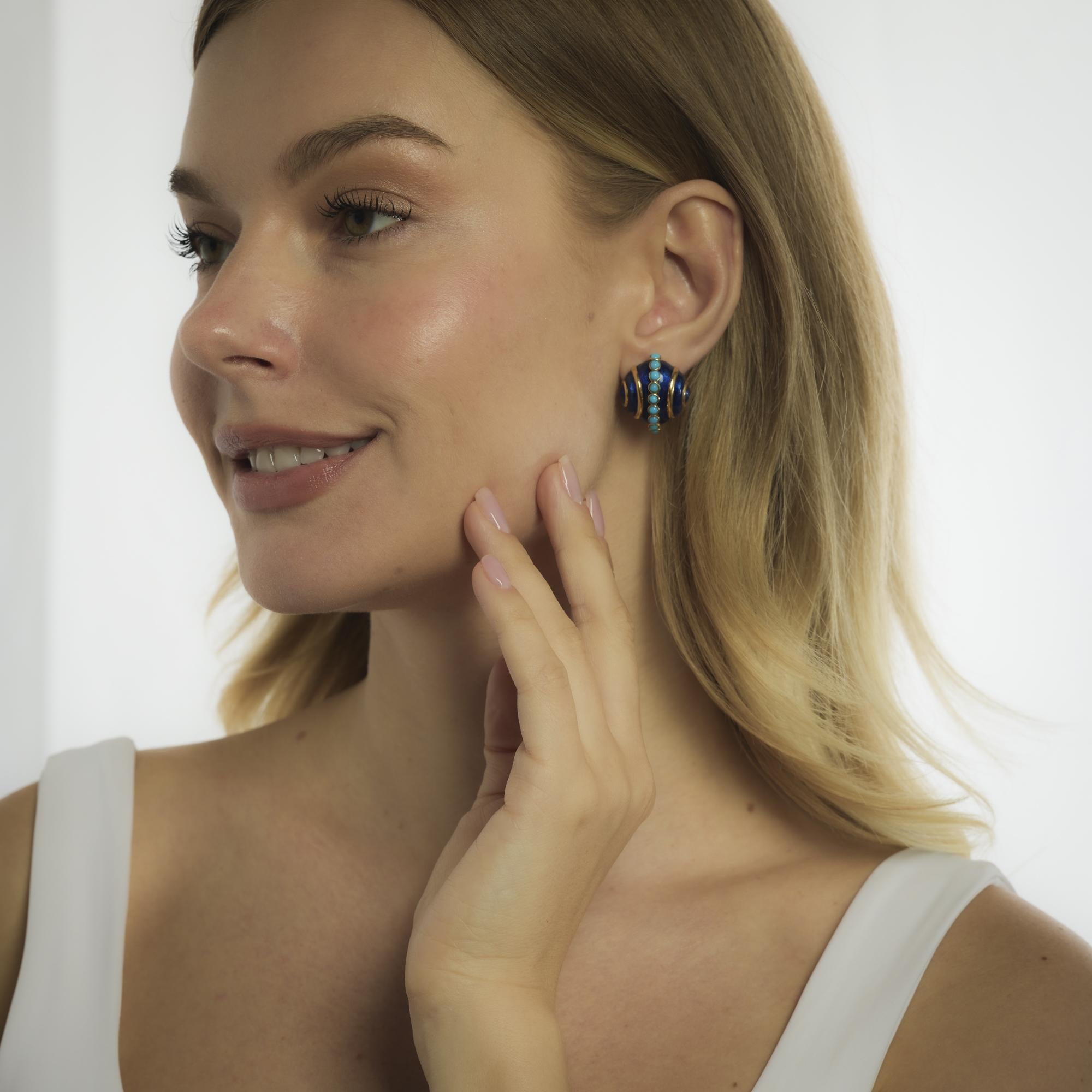 These vintage Tiffany & Co. earrings from the 1970’s feature twenty-two cabochon cut turquoise, each approximately 3.00 mm, set in radiant 18k yellow gold and framed by rich blue enamel. The combination of vibrant color and luxurious materials