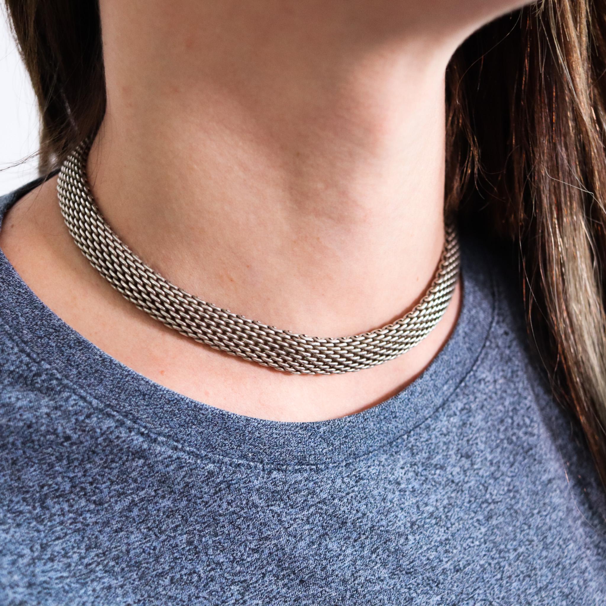 Necklace choker designed by Tiffany & Co.

An iconic and classic necklace, created by Tiffany & Co., back in the 1990's. It was crafted as a intricate mesh, woven from wires made up in solid .925/.999 sterling silver. It is fitted with a security