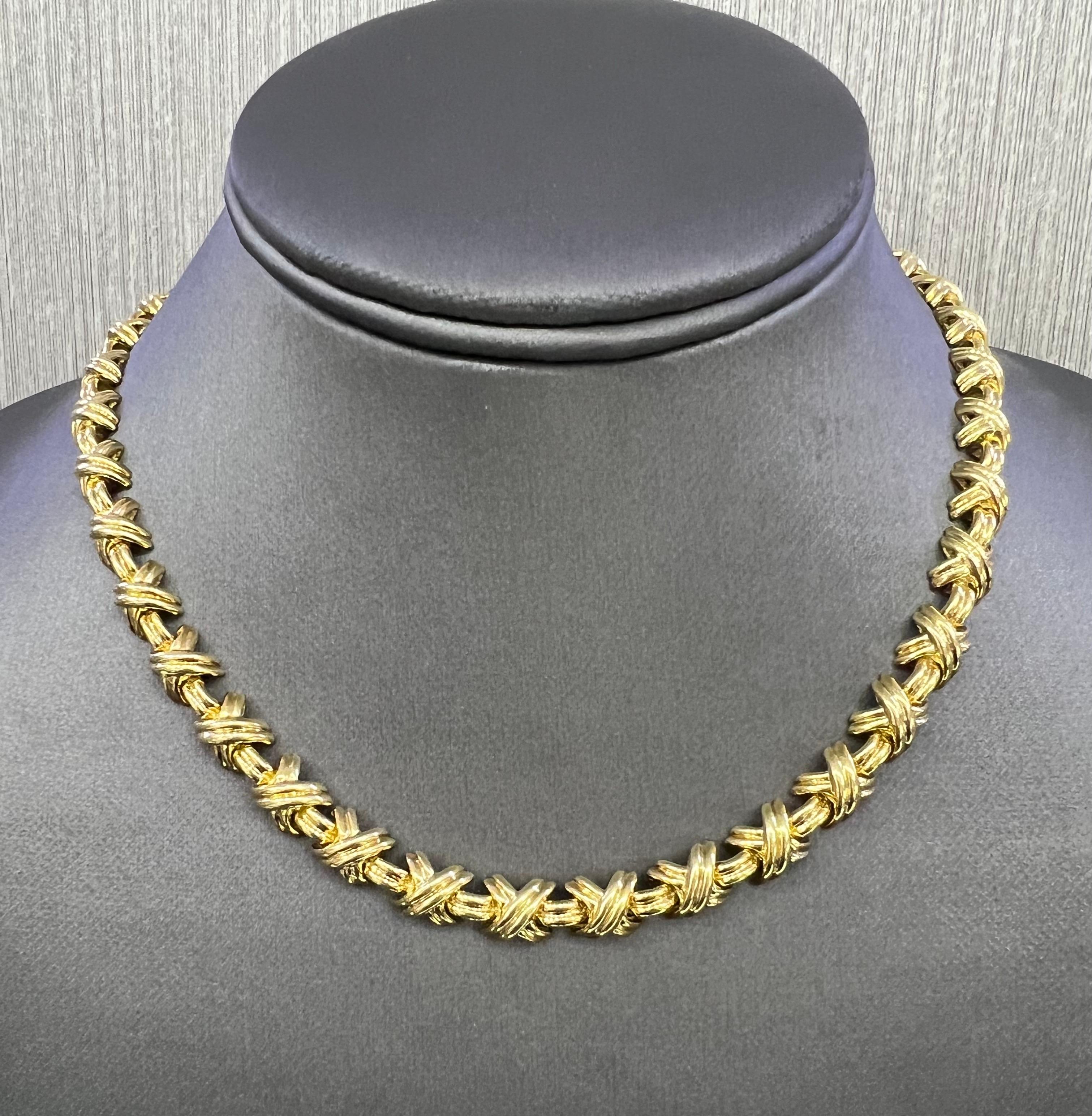 Beautiful necklace by famed designer Tiffany & Co. the necklace is crafted in solid 18k yellow gold and is from the X collection. 
   The necklace shows a 7.5 mm width and weighs 64.4 grams. The necklace measures 16