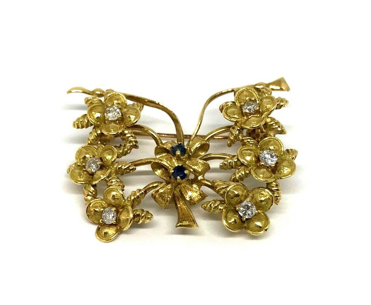 Circa 1960s Tiffany & Co. Butterfly pin made of 14k yellow gold features diamond and sapphire. Diamonds are round brilliant cut, G color, VS1 clarity, carat weight is 0.20 pts. Sapphires are round cut, about 0.80 pts.
Stamped with the Tiffany