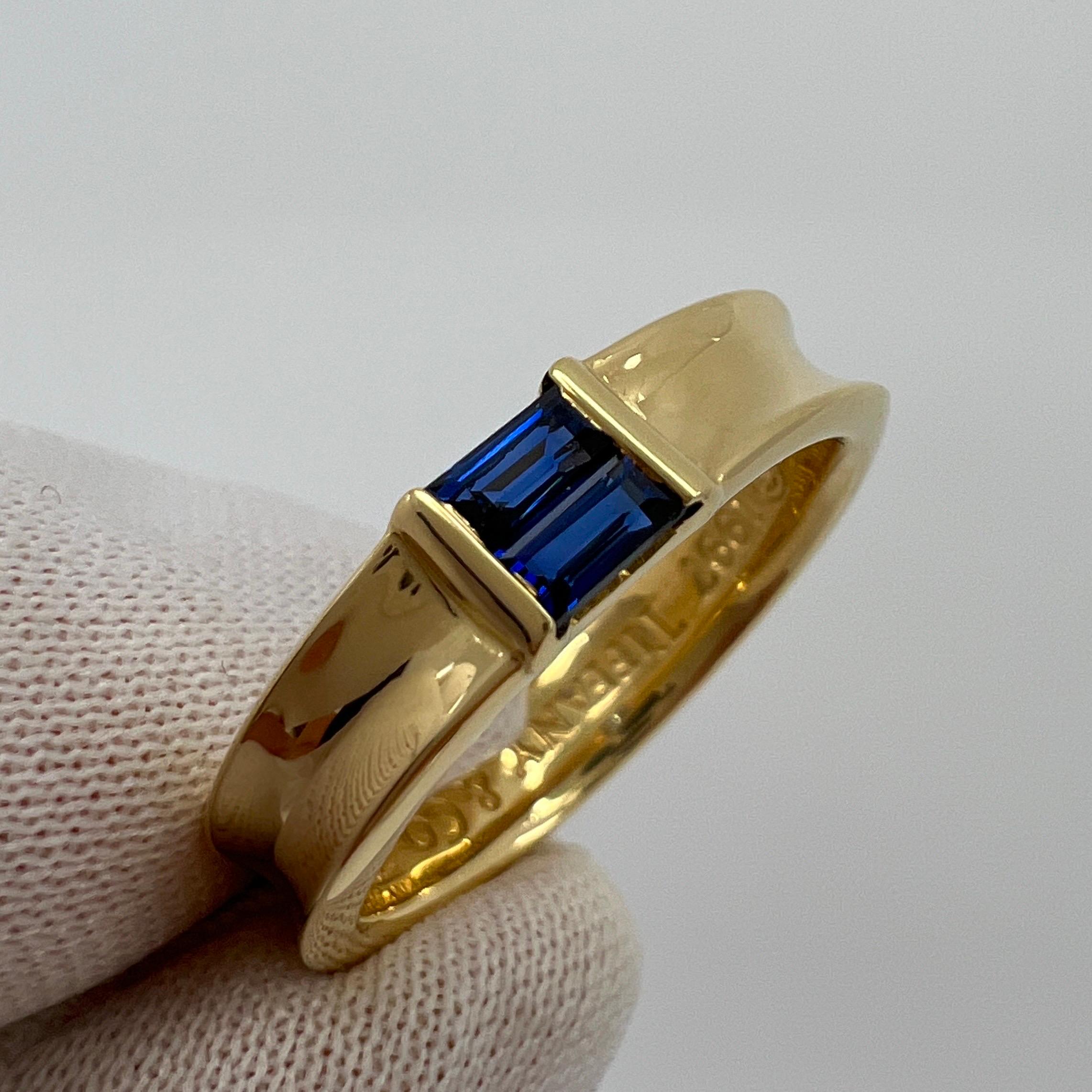 Tiffany & Co. Vivid Blue Sapphire Baguette Cut 18k Yellow Gold Stacking Ring.

A beautifully made yellow gold stacking ring set with x2 fine vivid blue baguette cut sapphires. Superb colour, clarity and cut. Measuring 4x2mm each.
Fine jewellery
