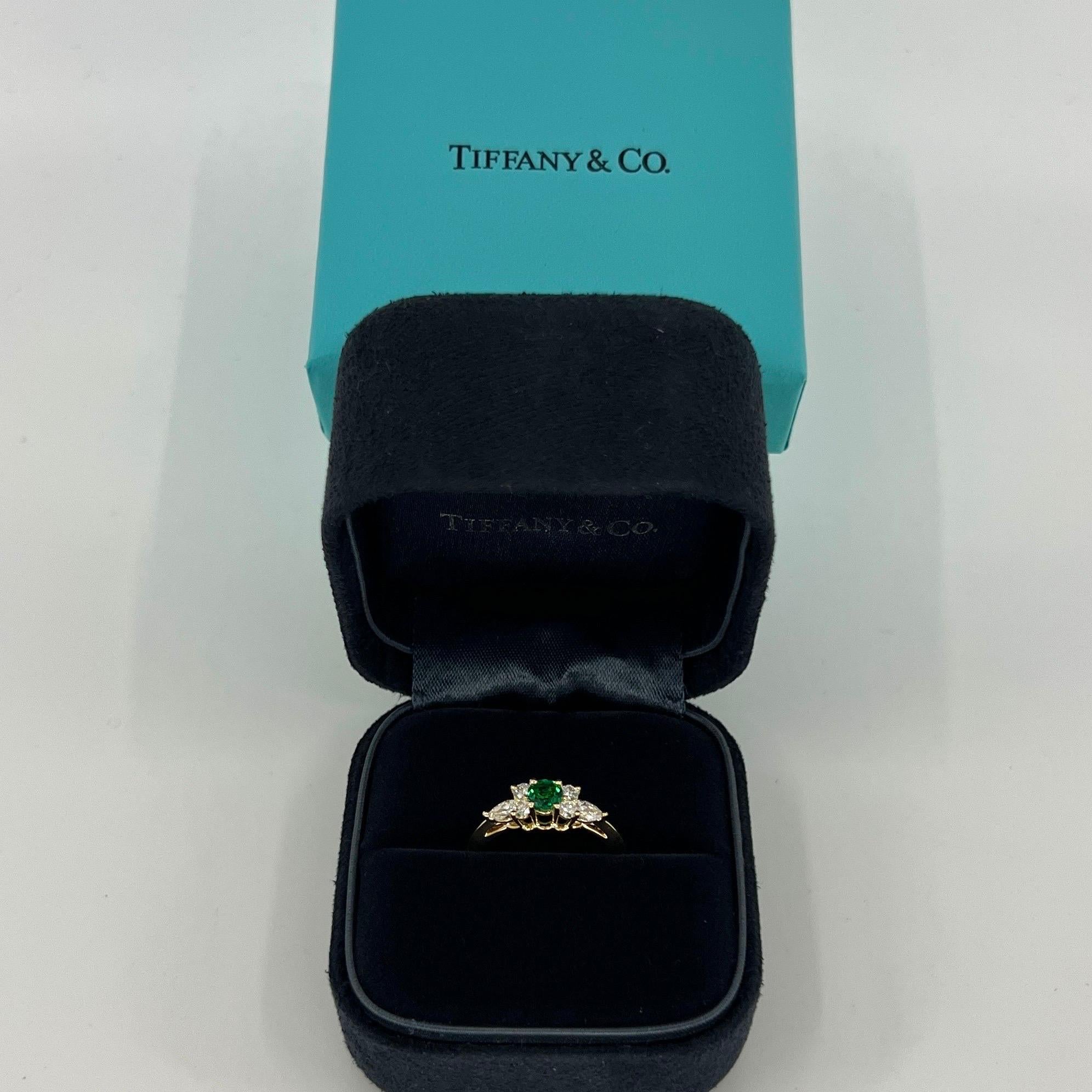 Rare Vintage Tiffany & Co. Emerald & Diamond Buttercup 18k Yellow Gold Ring.

A beautifully made yellow gold cluster ring set with a stunning 4.1mm vivid green round cut emerald. Superb colour, clarity and cut on this stone.

Surrounded by x6 top