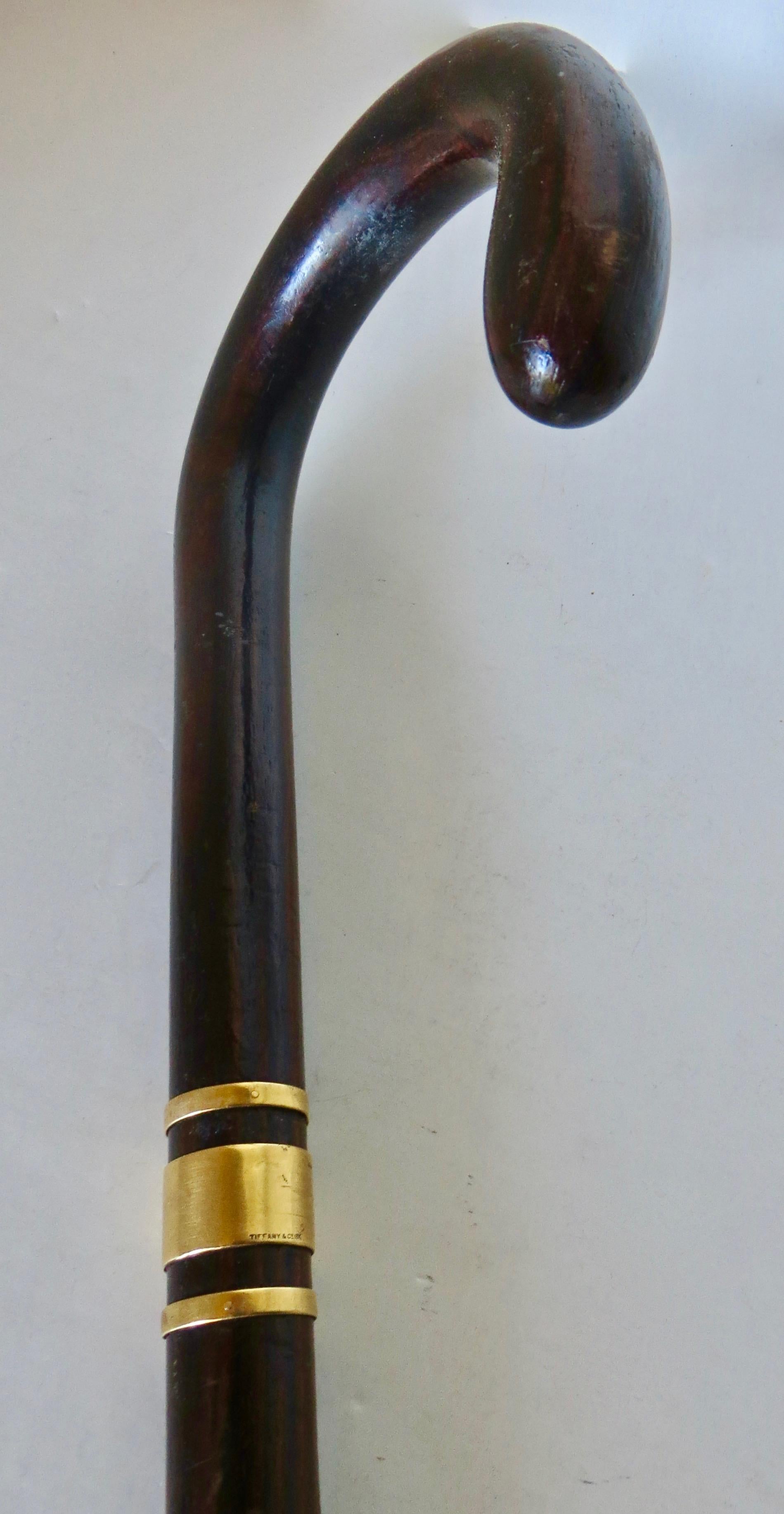 Fine walking stick made by luxury goods maker Tiffany & Co. of New York City; American, circa 1925. Made of fine quality grained black walnut, and standing 36
