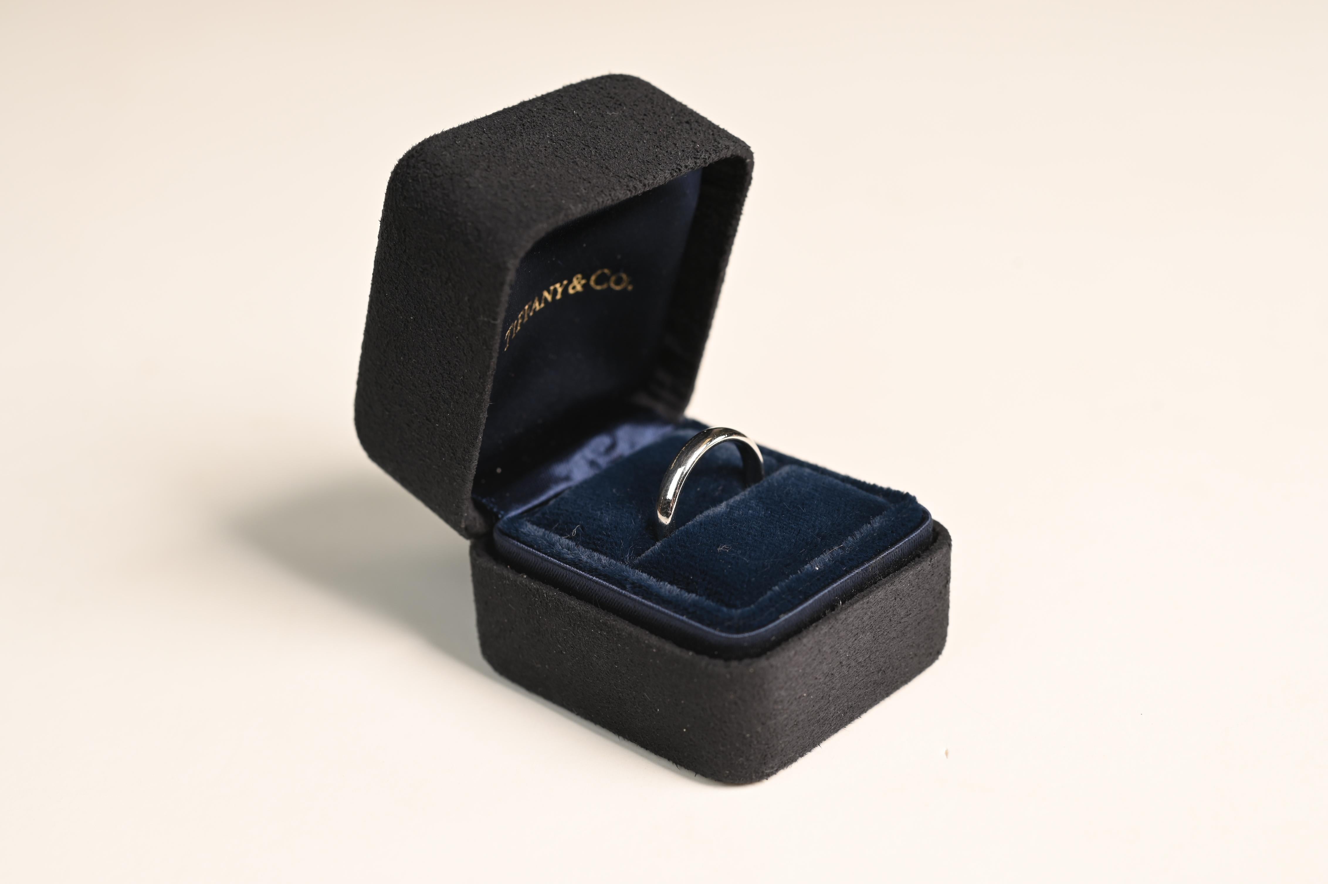 This timeless Tiffany & Co. platinum wedding band embodies elegance and simplicity. Crafted from high-quality platinum, the band features a sleek, polished finish that enhances its classic appeal. Measuring 3.05mm in width, this ring offers a