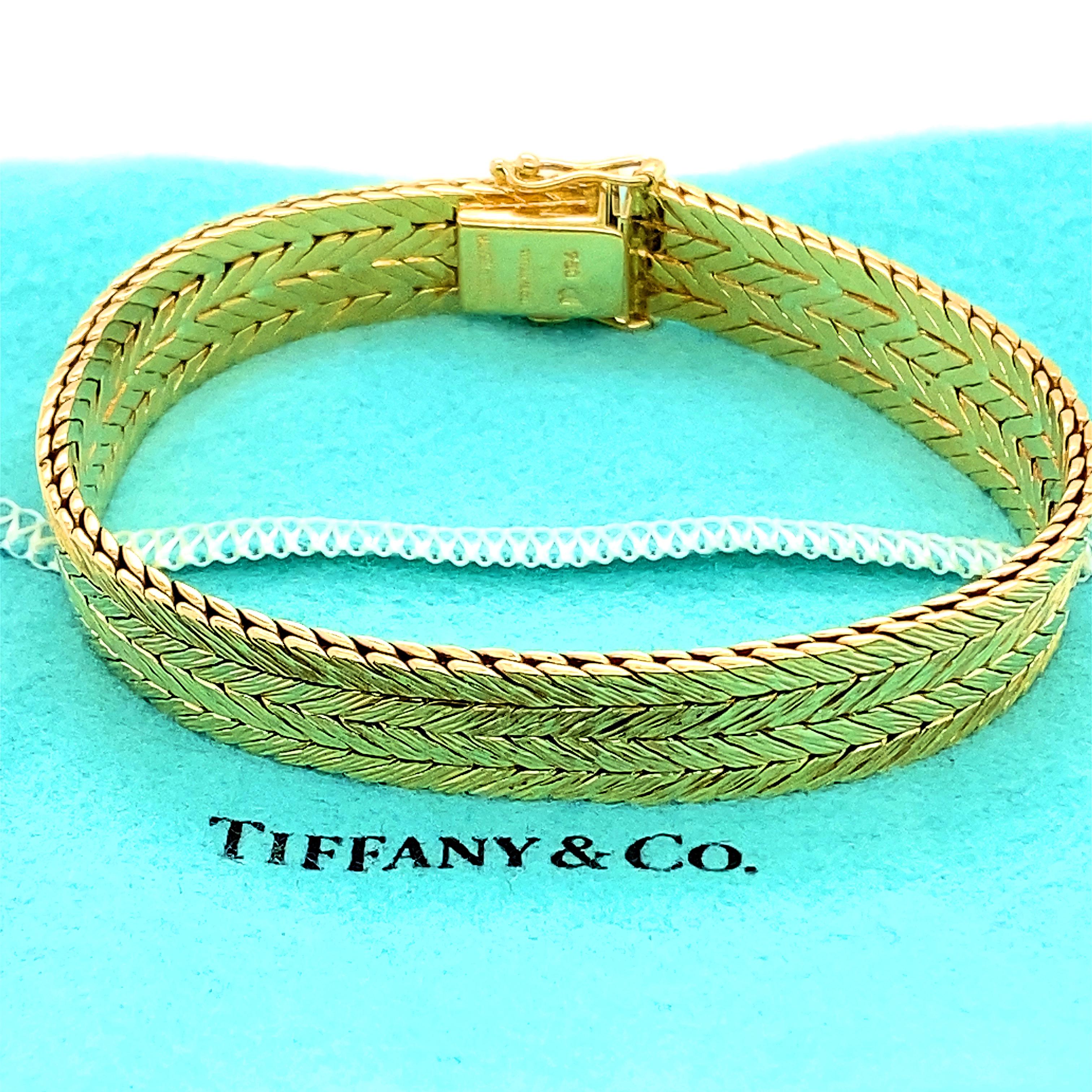 Tiffany & Co. Double Row Herringbone Woven Bracelet
Style:   Woven  
Metal:   18kt Yellow Gold
Made In:  West Germany Circa 1945 - 1990
Length:   7.5 inches
Width:  10 MM
Dept:  2.3 MM
Weight:  58.68 grams
Hallmark:   750 TIFFANY&CO MADE IN