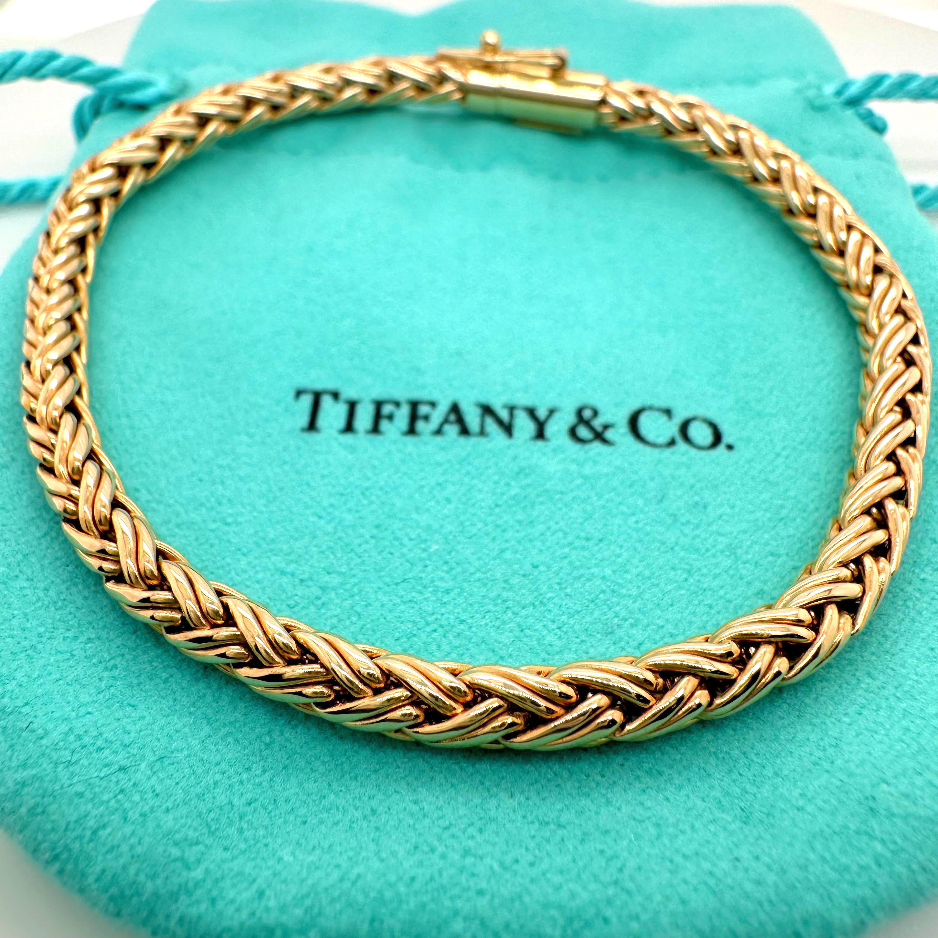 TIFFANY & CO. Braided Wheat Rope Bracelet
Style:  Rope
Metal:  14kt Yellow Gold
Size:  7.5 Inches
Hallmark:   TIFFANY&CO. 585
Includes:   T&C Jewelry Pouch

Sku##11383TCF060623