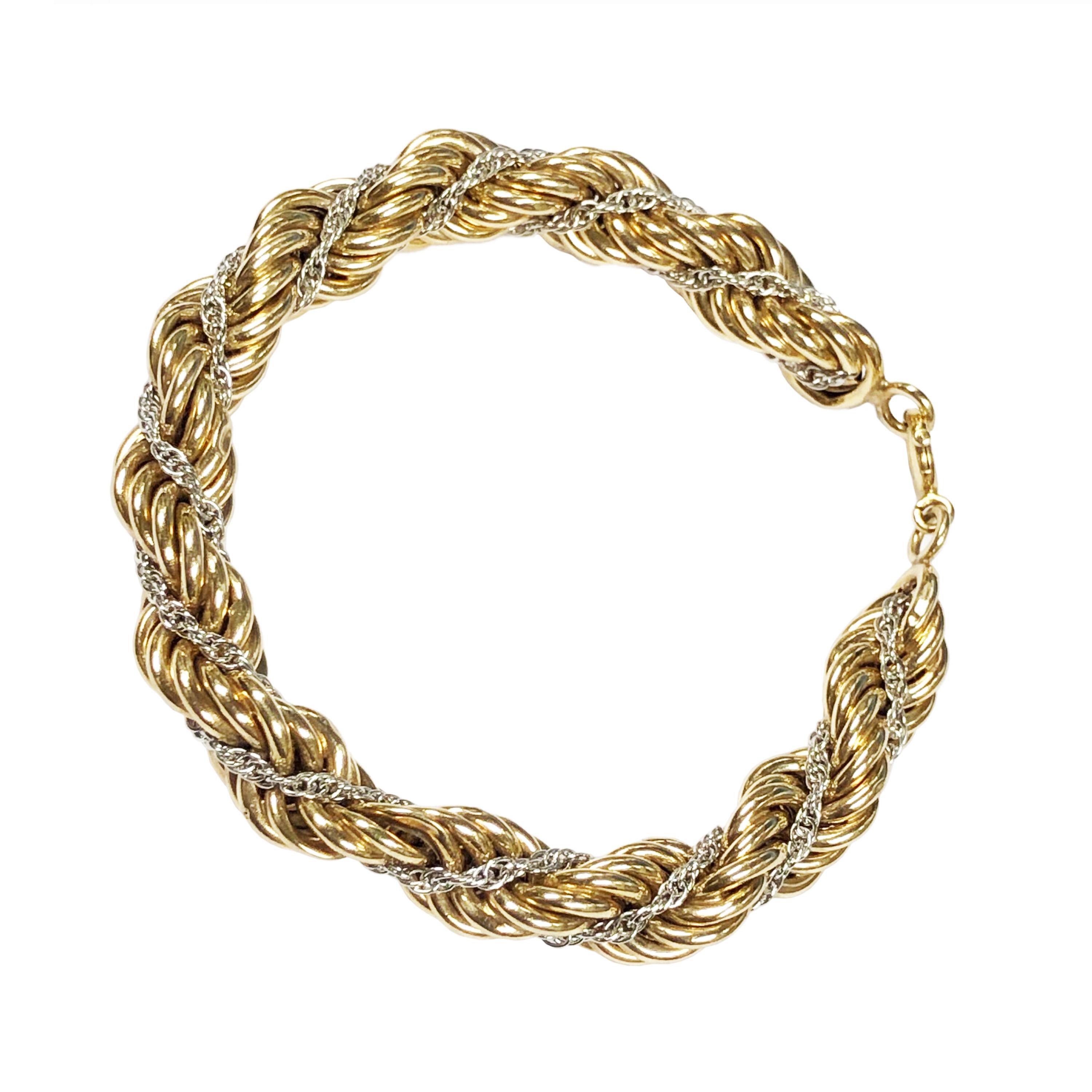 Circa 1980s Tiffany & Company 14K Yellow and White Gold Rope Bracelet comprised of a White gold chain interwoven in the larger Yellow Gold Bracelet, measuring 8 inches in length 3/8 inch wide and weighing 29 Grams. Excellent condition and comes in