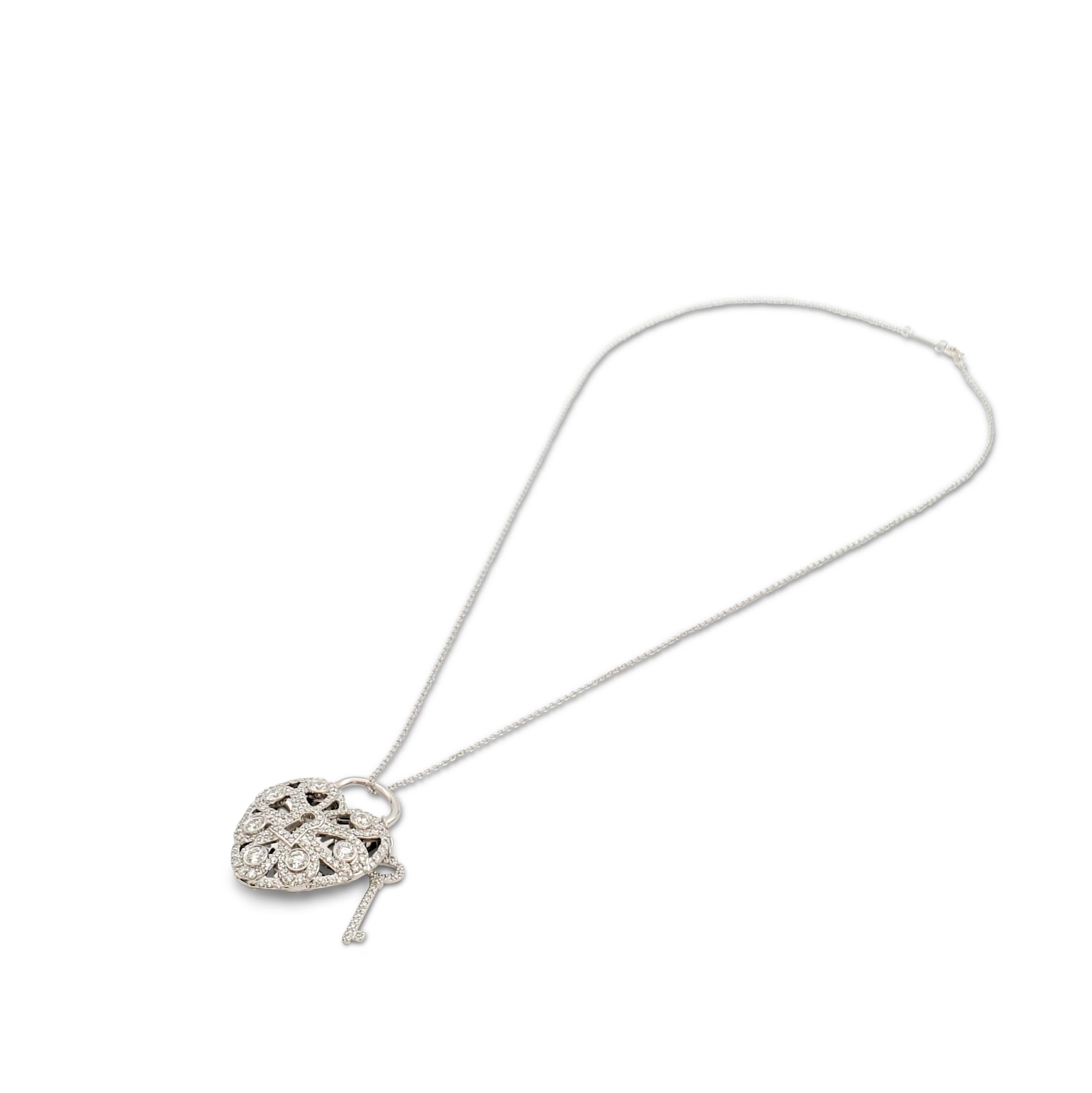 Authentic Tiffany & Co. 3-dimensional 'Filigree' heart and key pendant crafted in 18 karat white gold and set with an estimated 1.44 carats of round brilliant cut diamonds (F-G color, VS clarity) at the front. The reverse features beautiful