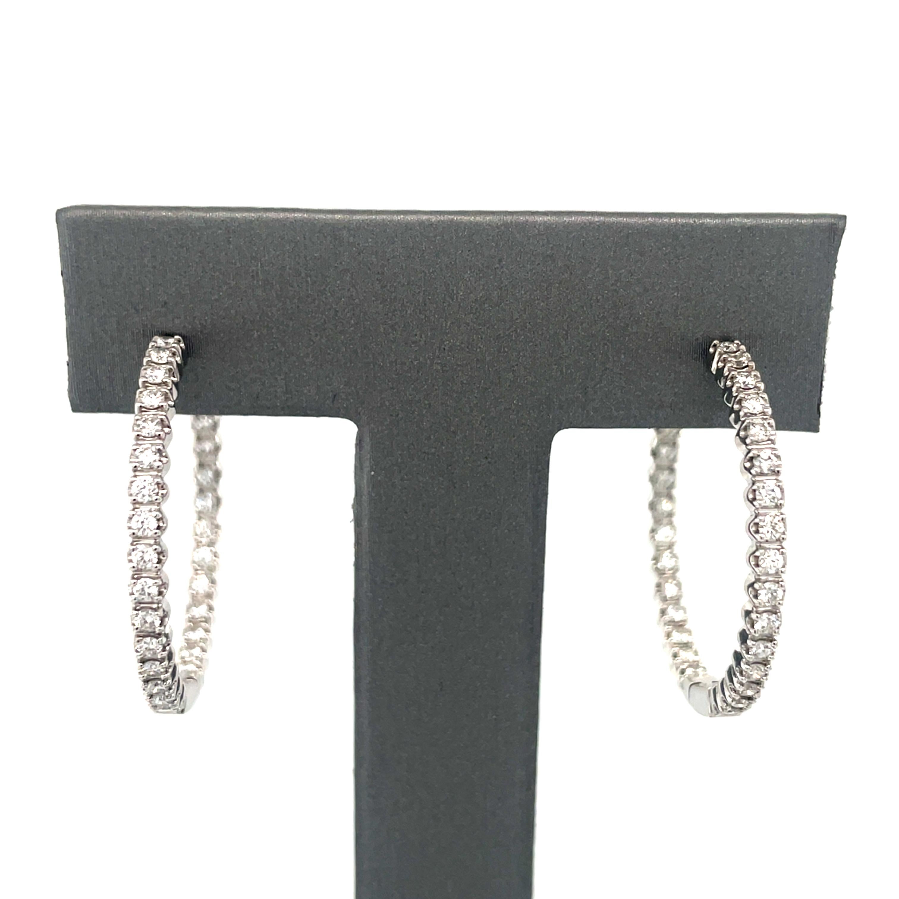 In a sleek and modern design, these Tiffany & Co. hoop earrings contain 58 round brilliant cut diamonds weighing 0.90 carat total, in an inside-out design.

Accompanied by a Tiffany & Co. box and pouch.

Measurements: 1 inch long
Metal: 18K white