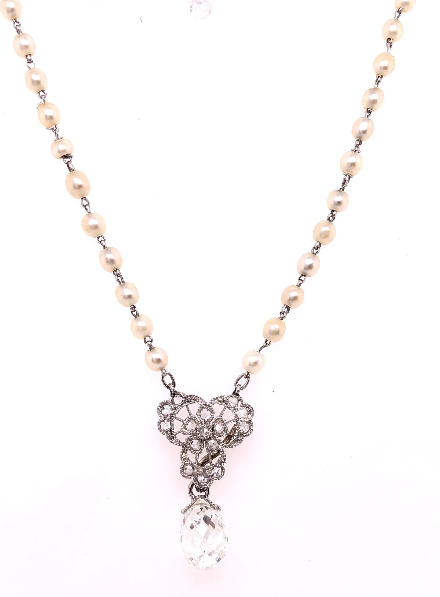 Antique Tiffany & Co. White Gold Beaded Pearl Necklace with Diamonds and a Large Briolette Cut Diamond. Set on a 19 inch chain having 100 2.5mm pearls separated by three white gold and pave-set diamond rondel spacers with a large pendant of white