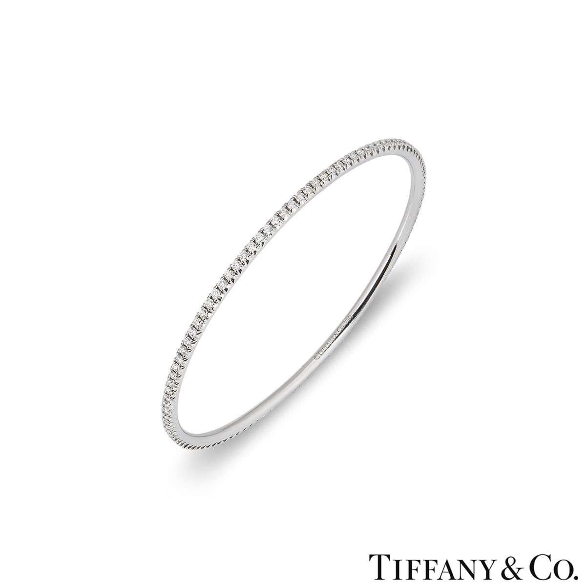 An elegant white gold diamond bangle by Tiffany & Co. The bangle features claw set round brilliant cut diamonds with a total weight of approximately 2.10ct. The bangle measures 2.3mm in width and has a circumference of 19cm. The bangle has a gross