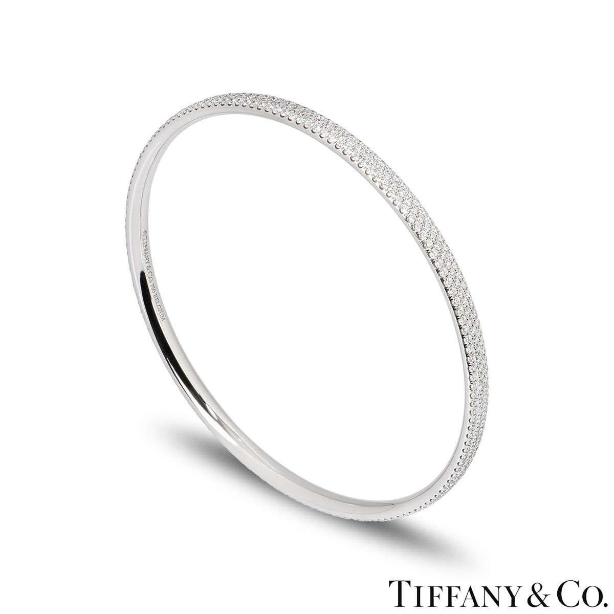 An elegant 18k white gold diamond bangle by Tiffany & Co. The bangle features three rows of pave set round brilliant cut diamonds. The bangle measures 6.9cm in diameter and has a gross weight of 21.8 grams.

The bangle comes complete with a