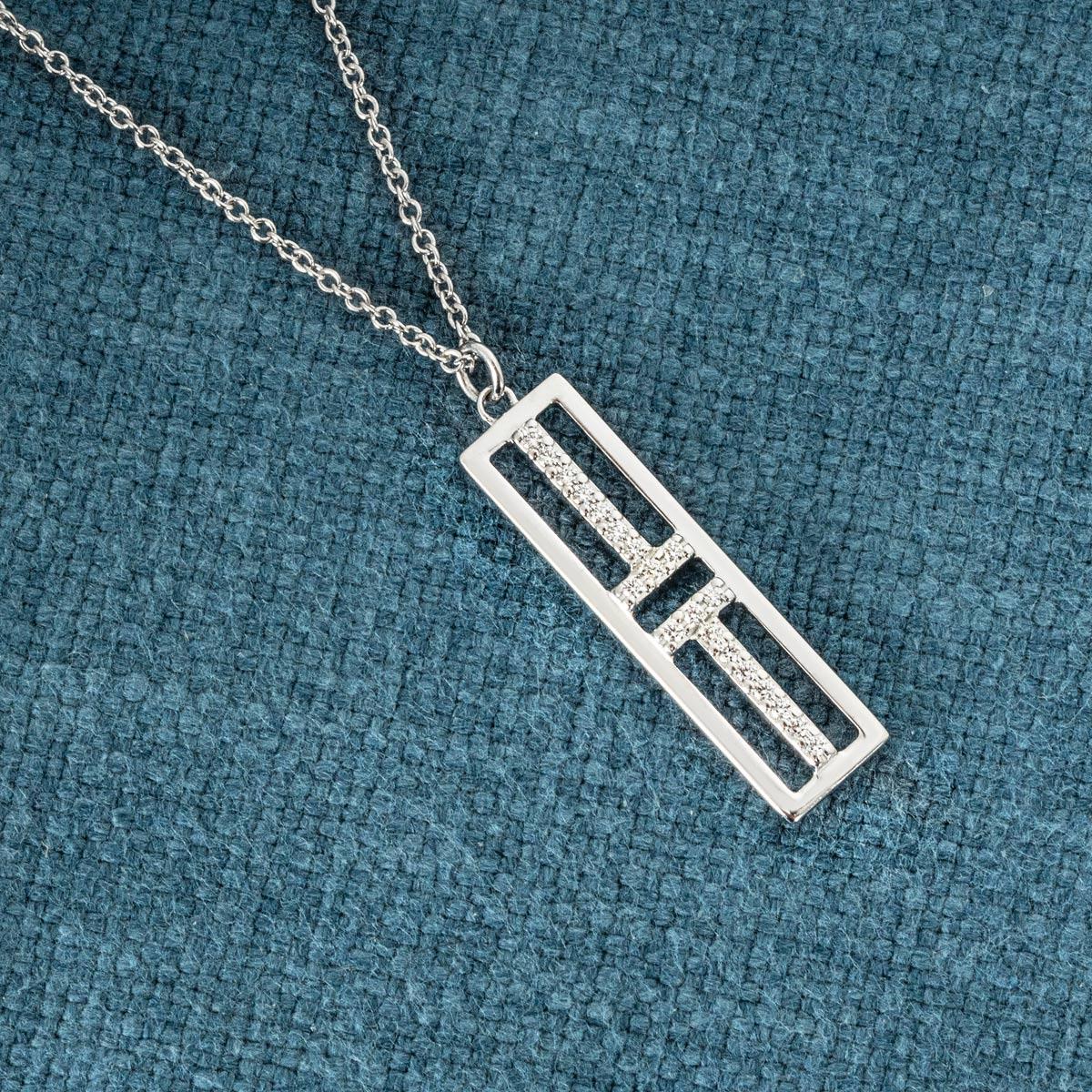 A stunning 18k white gold diamond pendant by Tiffany & Co. from the Tiffany T collection. The pendant features an openwork rectangular motif with the iconic double T, set with a total of 20 round brilliant cut diamonds, with an approximate total