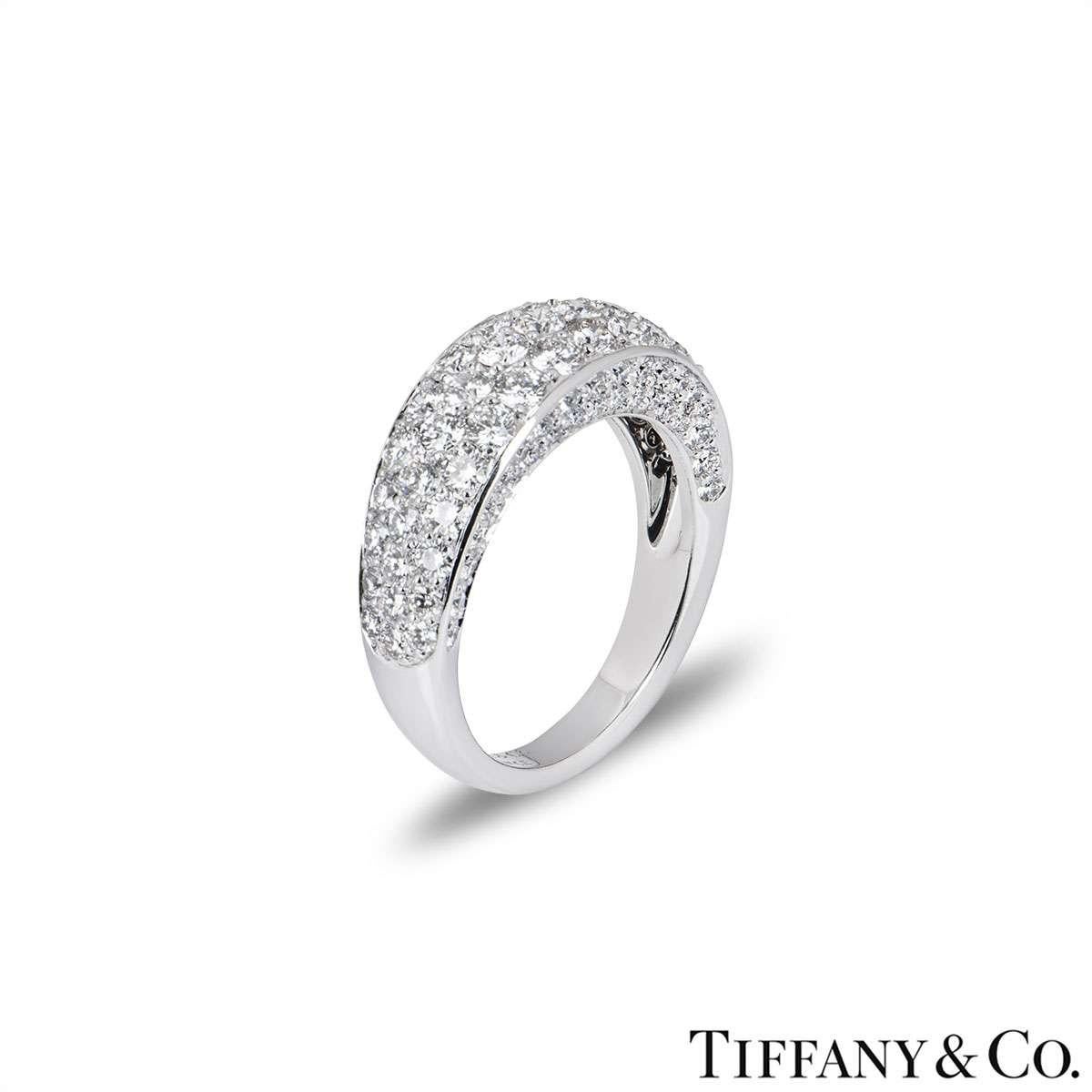 An 18k white gold diamond set ring by Tiffany & Co. The ring is pave set with round brilliant cut diamonds around the front and sides of the band. The ring measures 4mm in height and is a size UK Q / EU 57 / US 8, with a gross weight of 8.2