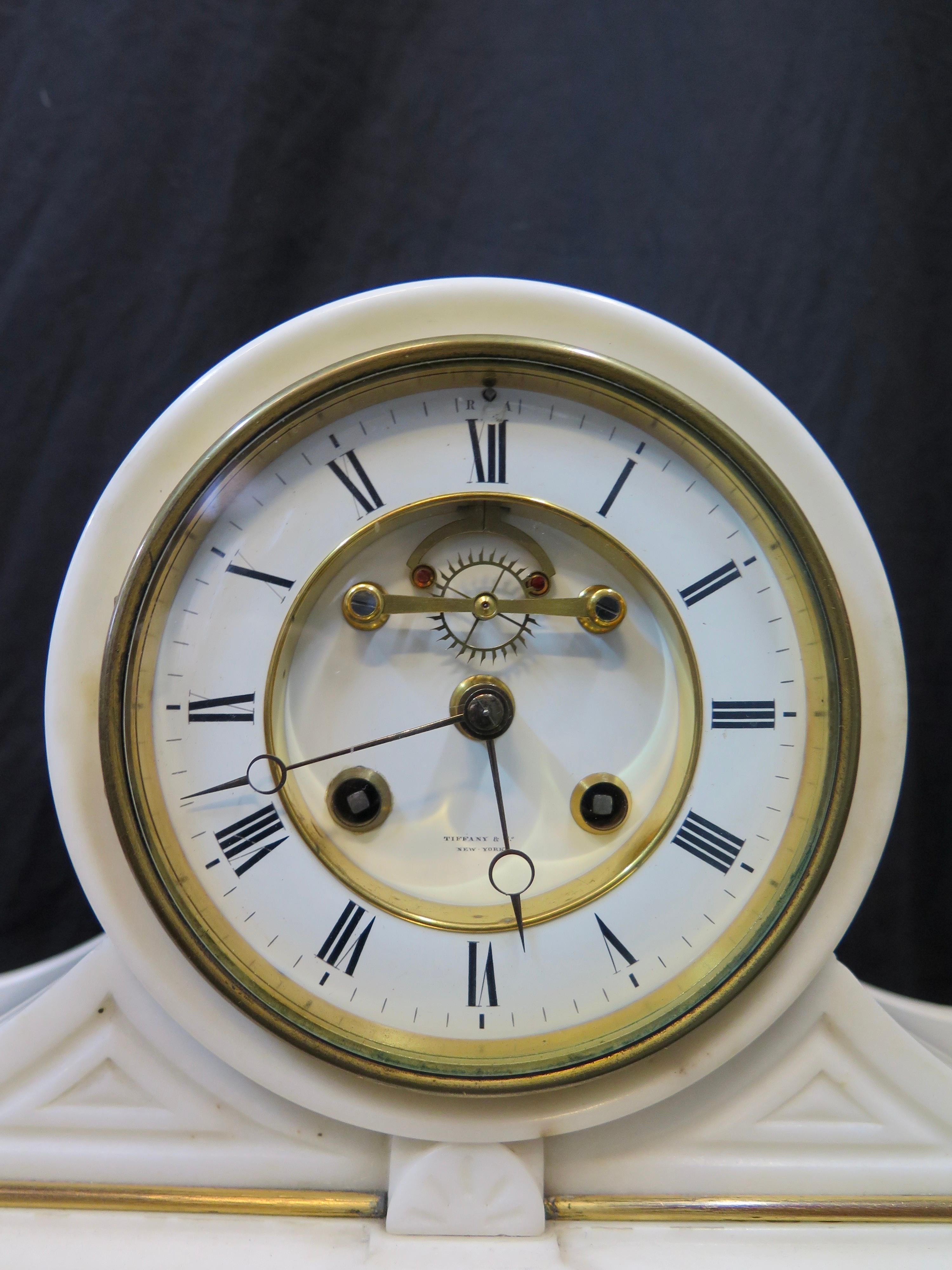 This magnificent vintage late 19th century mantle clock was made for Tiffany & Co. The oversize white Italian marble mantle clock case is decorated with detailed hand painted Sevres porcelain plaques. These framed plaques depict romantic scenes of