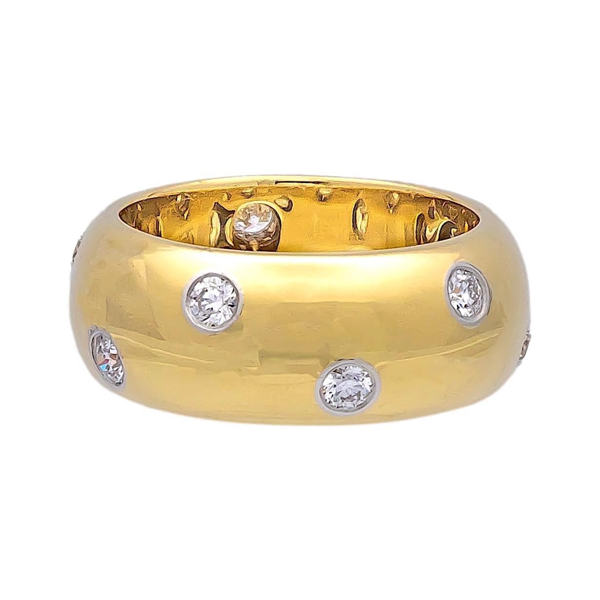 Tiffany & Co. Etoile Domed Band Ring finely crafted in 18 Karat yellow gold measuring 8mm wide with 10 round brilliant cut diamonds set in platinum bezels weighing 0.40 carats total weight approximately. The band is domed and comfort fit. Fully