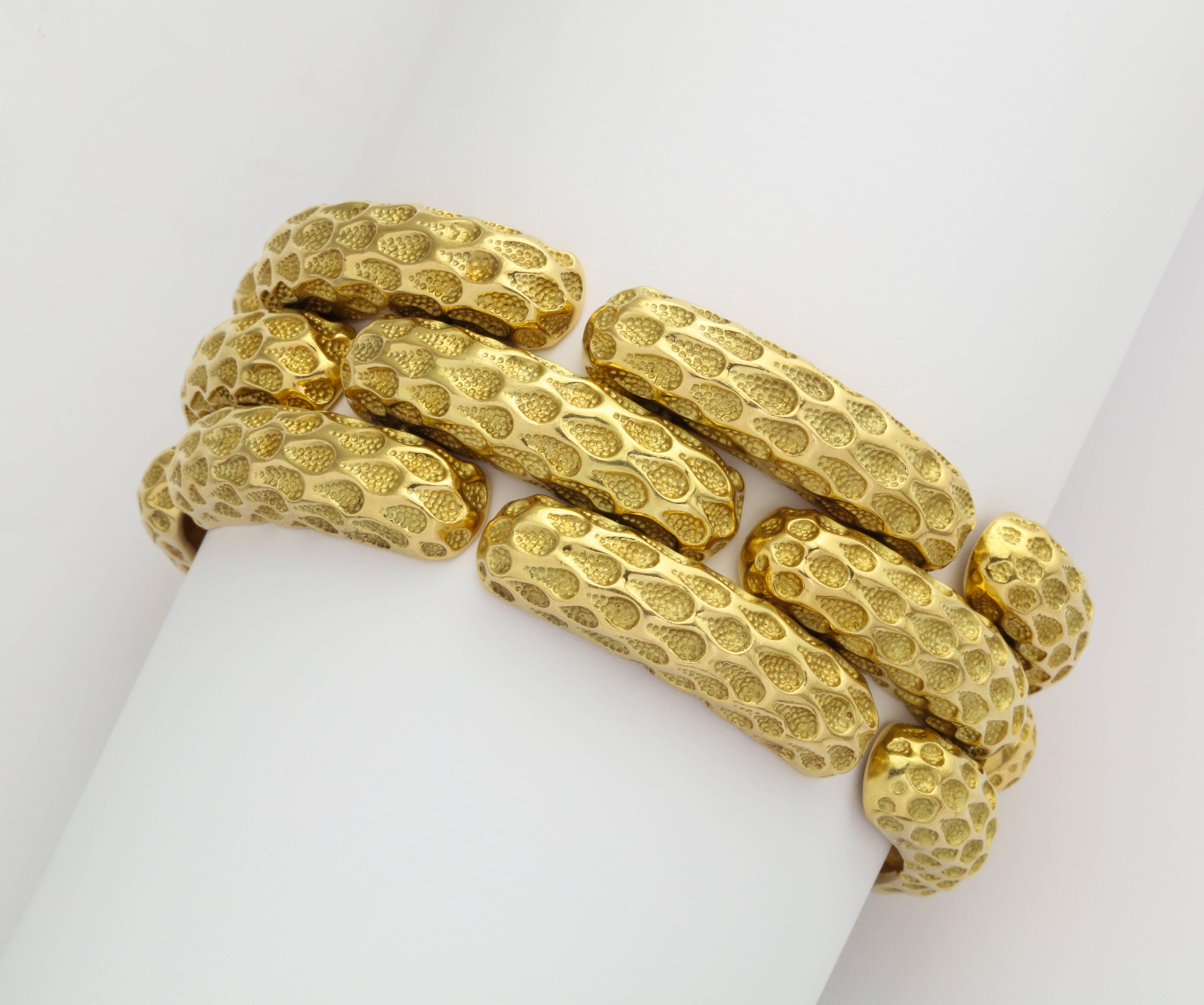 A chic and substantial 1970s Tiffany bracelet in 18K gold with a polished surface pattern replicating net, contrasted by hand applied texture deep in the recesses, all nicely articulated to be comfortably worn day into night. Marked Tiffany - Italy