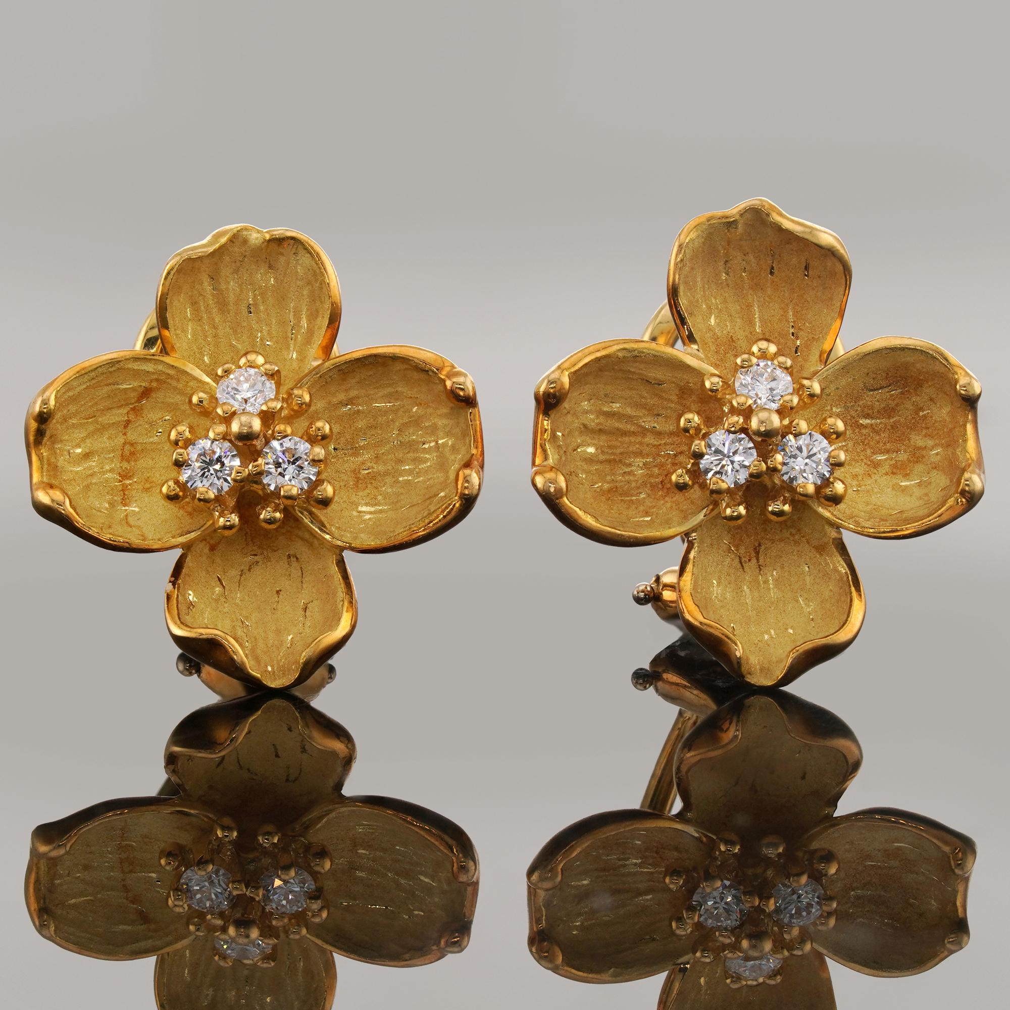 These gorgeous vintage Tiffany & Co. earrings from the elegant floral Dogwood collection feature a four-petaled wild rose flower design crafted in 18k yellow gold and set with brilliant-cut round E-F-G VVS1-VVS2 diamonds in the center, weighting an