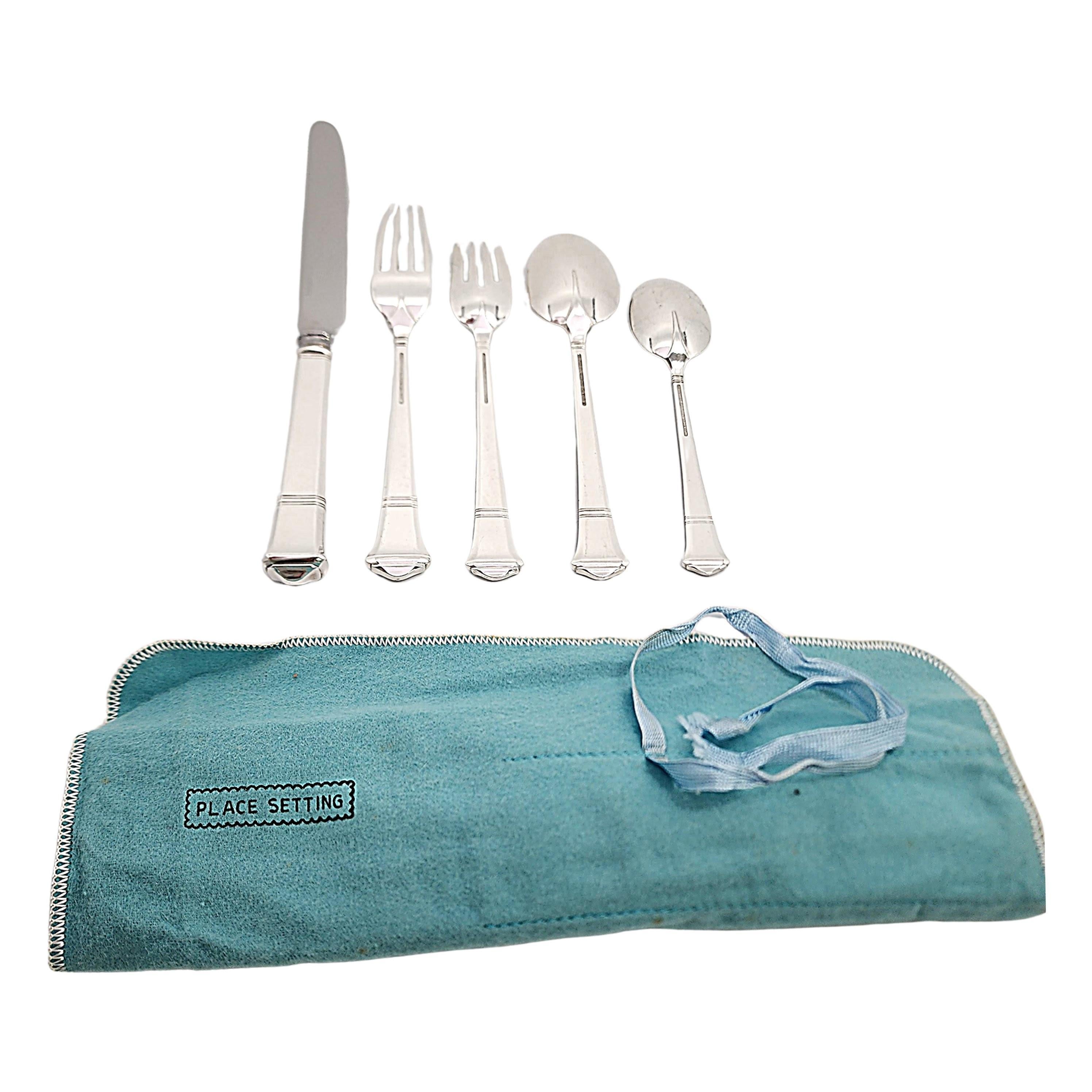 5pc dinner place setting by Tiffany & Co in the Windham pattern with pouch.

No monogram

Beautiful 5pc dinner setting includes knife, dinner fork, salad fork, place/oval soup spoon and teaspoon. Tiffany's Windham pattern was designed by Arthur