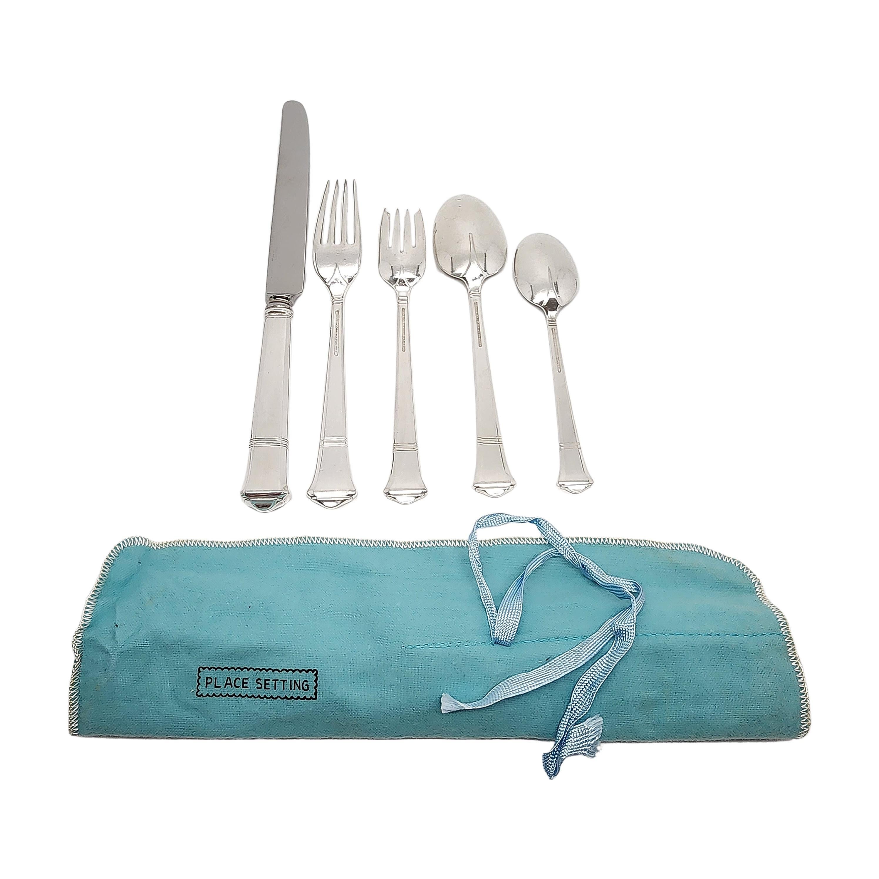 5pc dinner place setting by Tiffany & Co in the Windham pattern with pouch.

No monogram

Beautiful 5pc dinner setting includes knife, dinner fork, salad fork, place/oval soup spoon and teaspoon. Tiffany's Windham pattern was designed by Arthur