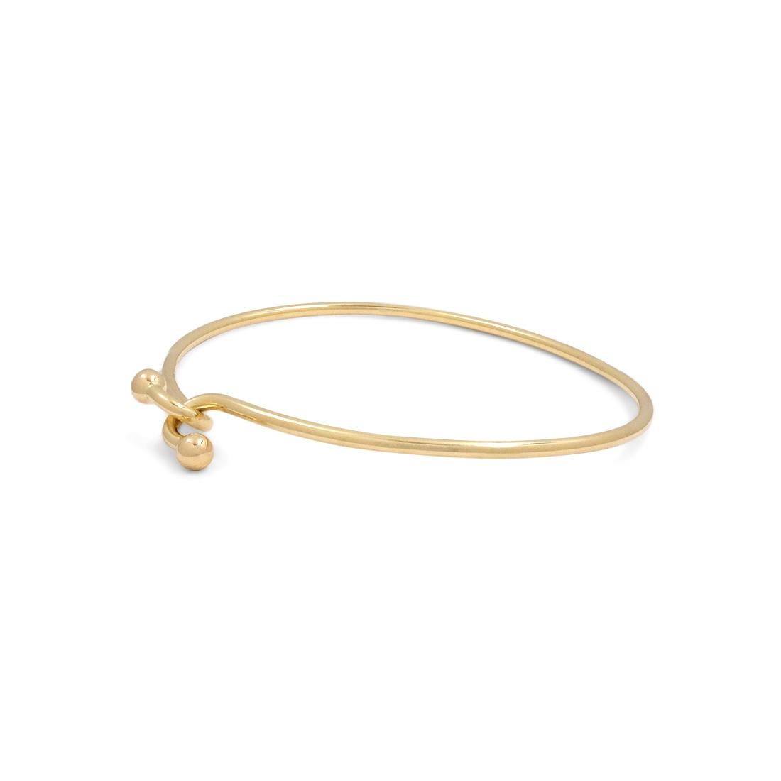 Authentic Tiffany & Co. wire hook bracelet crafted in 18 karat yellow gold. Will fit up to a 6 1/2 inch wrist. Signed Tiffany & Co., 750. The bracelet is not presented with the original box or papers. CIRCA 2010s.

Brand: Tiffany & Co. 
Collection: